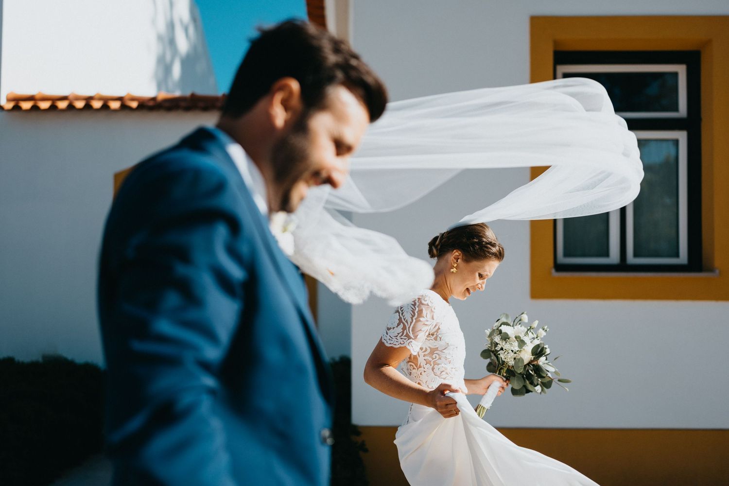 Artistic wedding photography sequence showing flowing veil movement against blue sky.