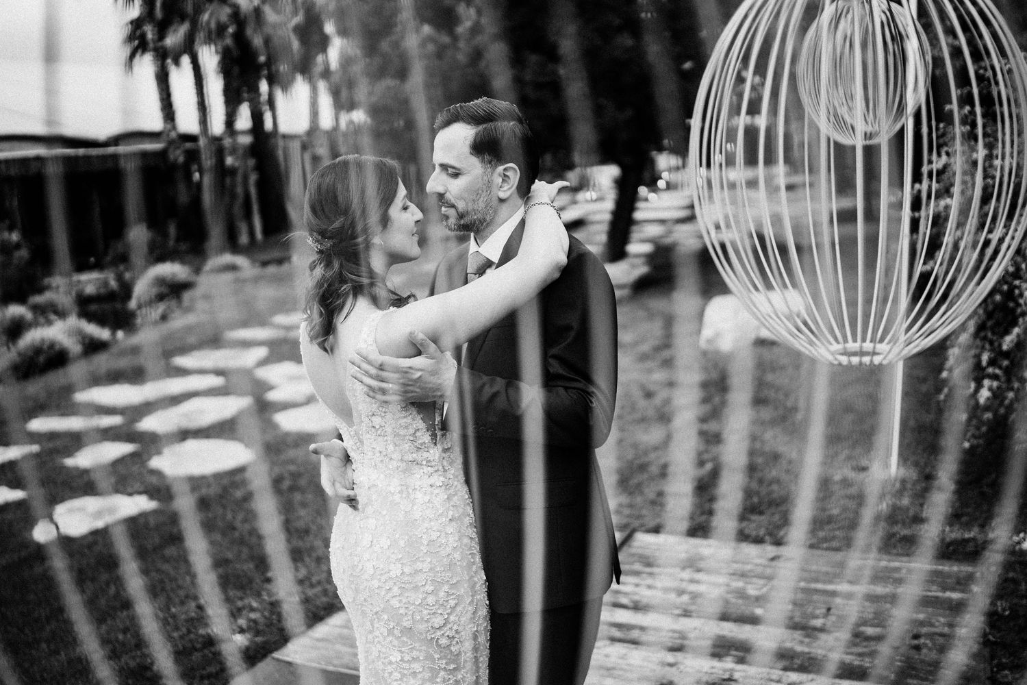 Wedding celebration with decorative birdcage elements in black and white.