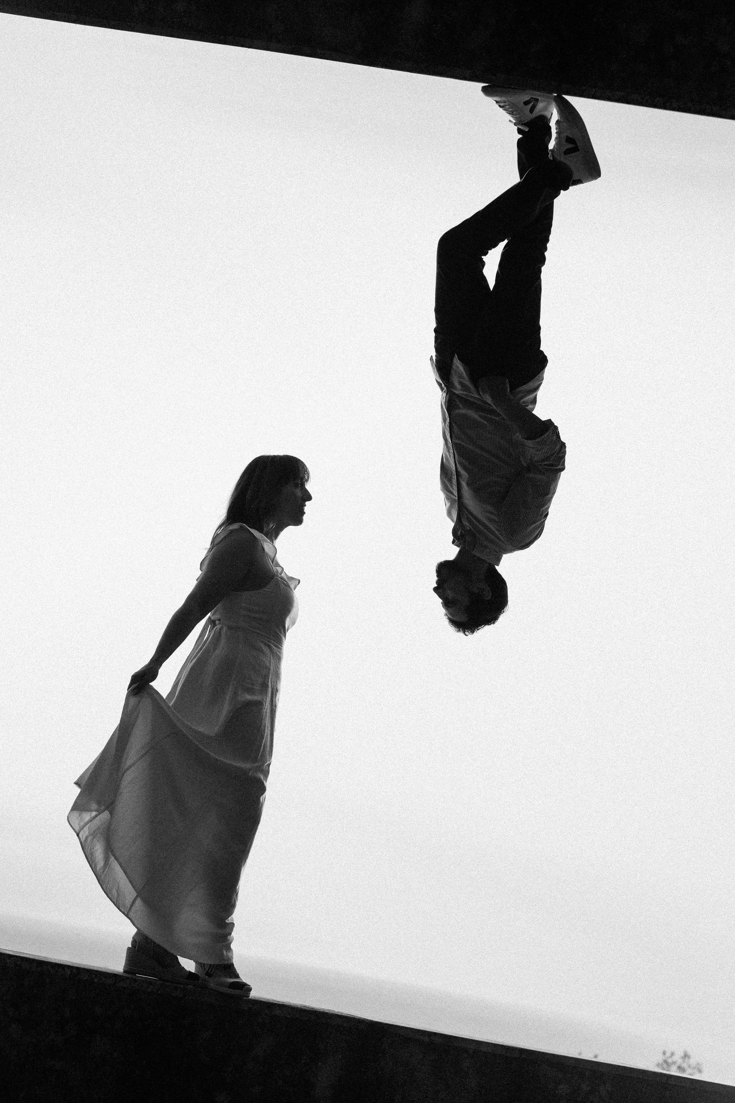 Artistic black and white silhouettes of a couple in dramatic poses.