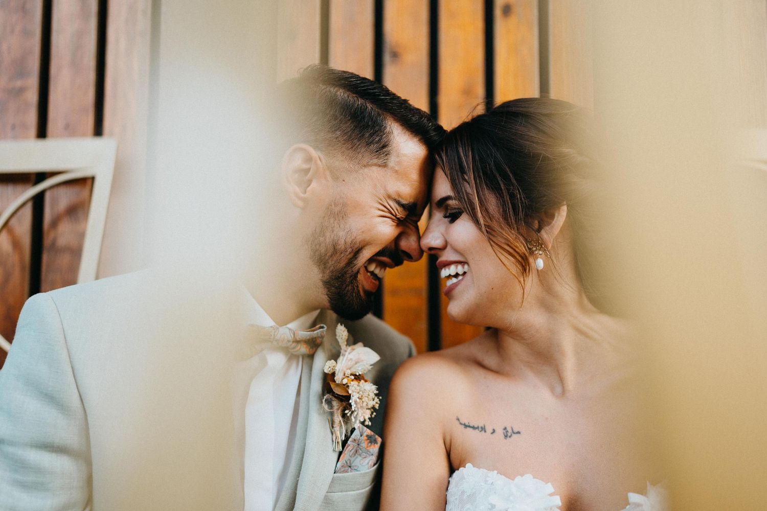 Intimate wedding moment captured indoors with warm lighting and floral details.