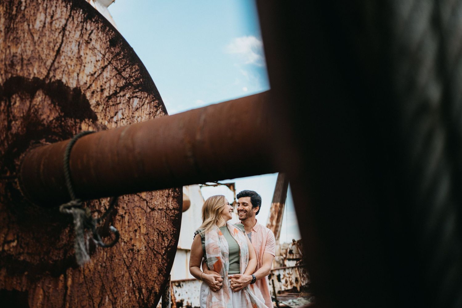 Romantic couple photos captured through creative framing against rocky backdrop.