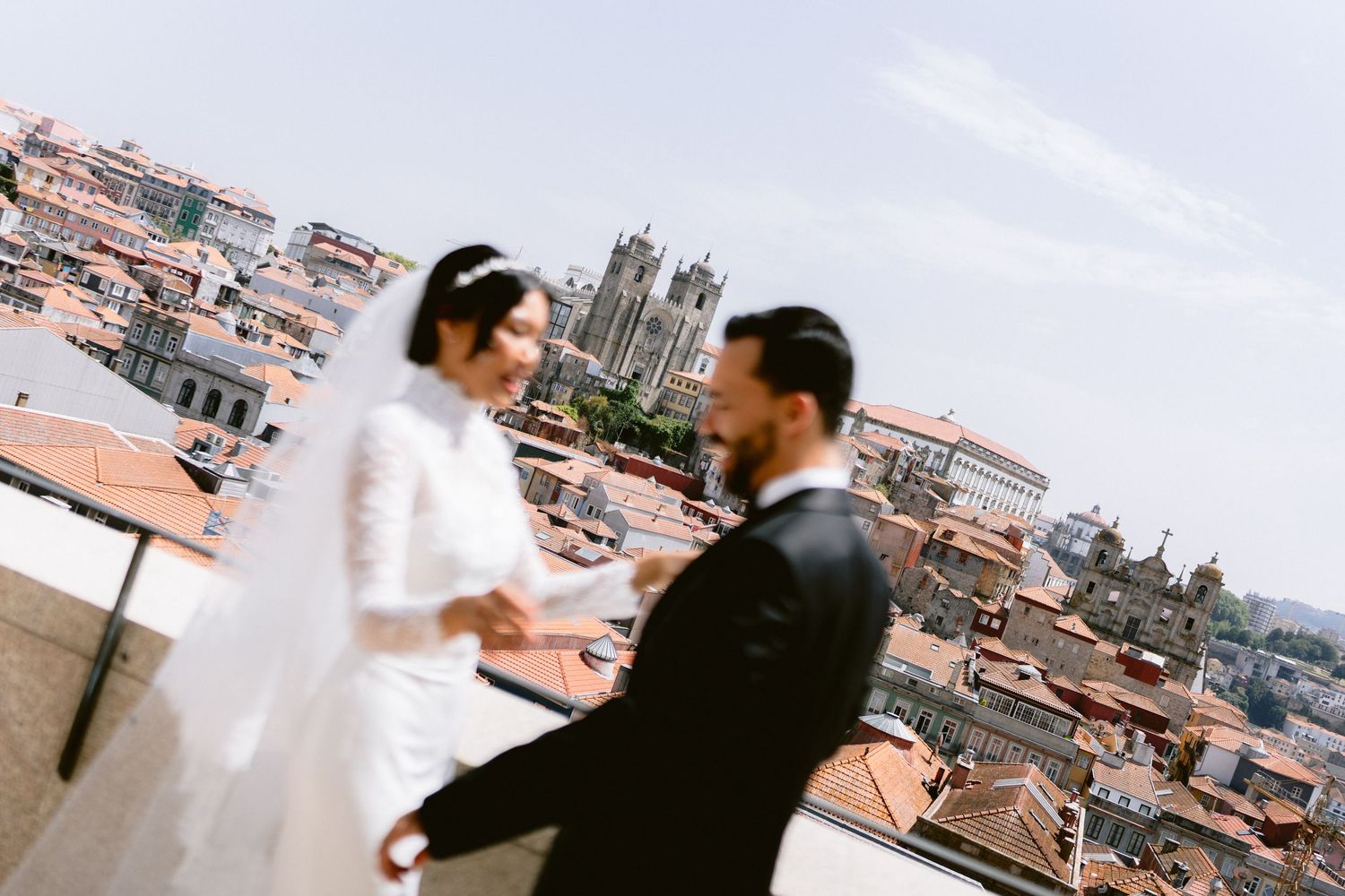 Panoramic rooftop wedding photos overlooking European city architecture.