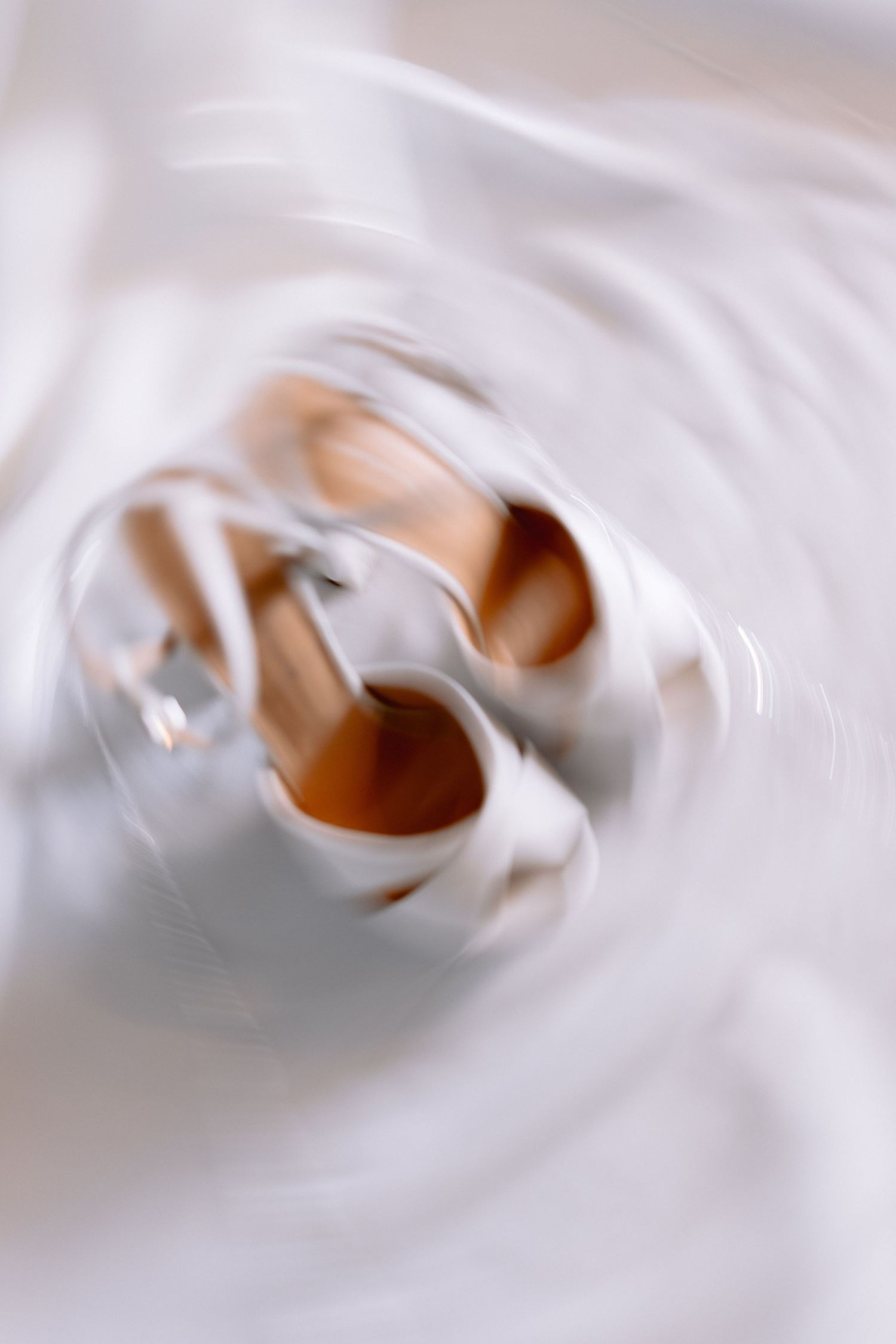 Abstract swirling white cream or foam texture creating a smooth spiral pattern.