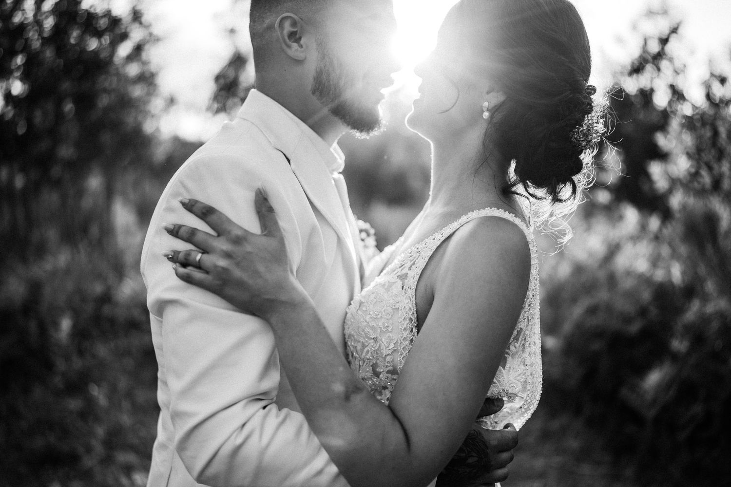 Romantic sunset wedding portrait with couple in soft golden light.