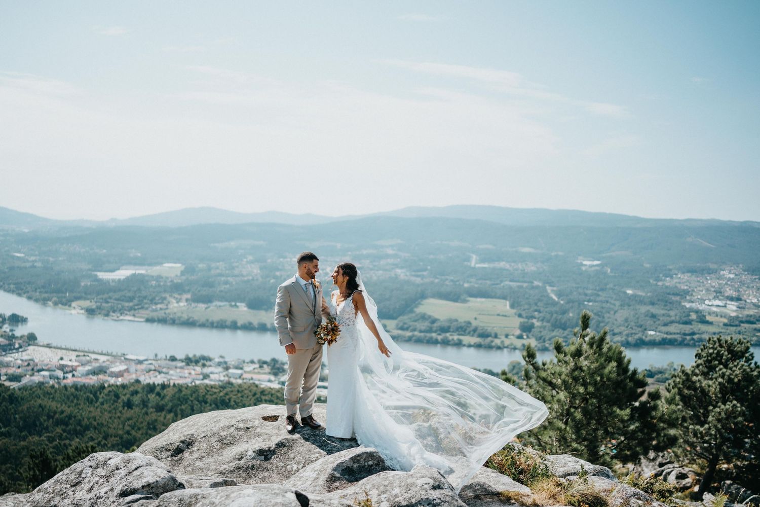 Scenic mountain vista wedding photography with dramatic coastal views in the background.