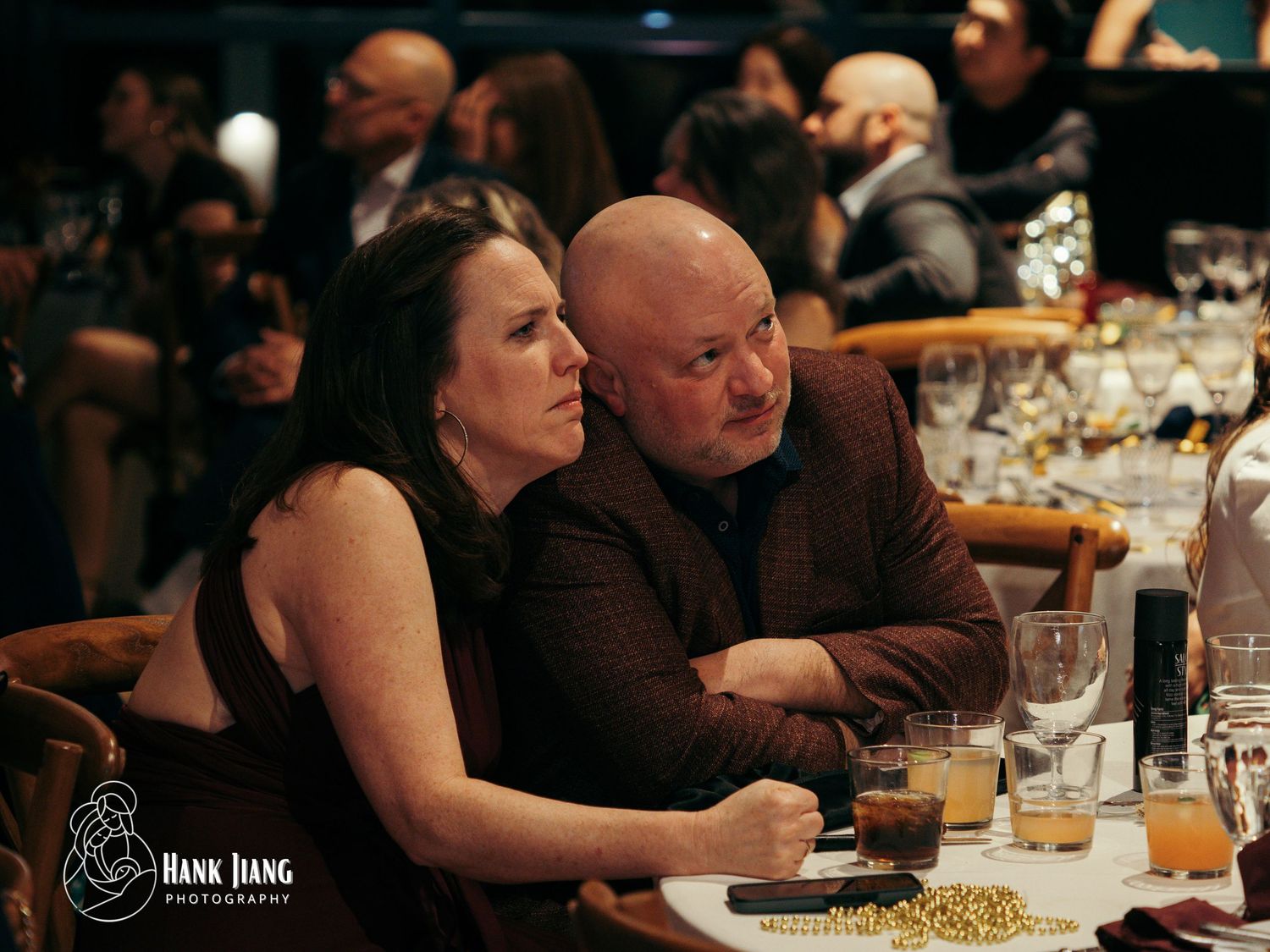 Couple sitting together at formal event dinner table, photographed by Hank Jiang Photography.