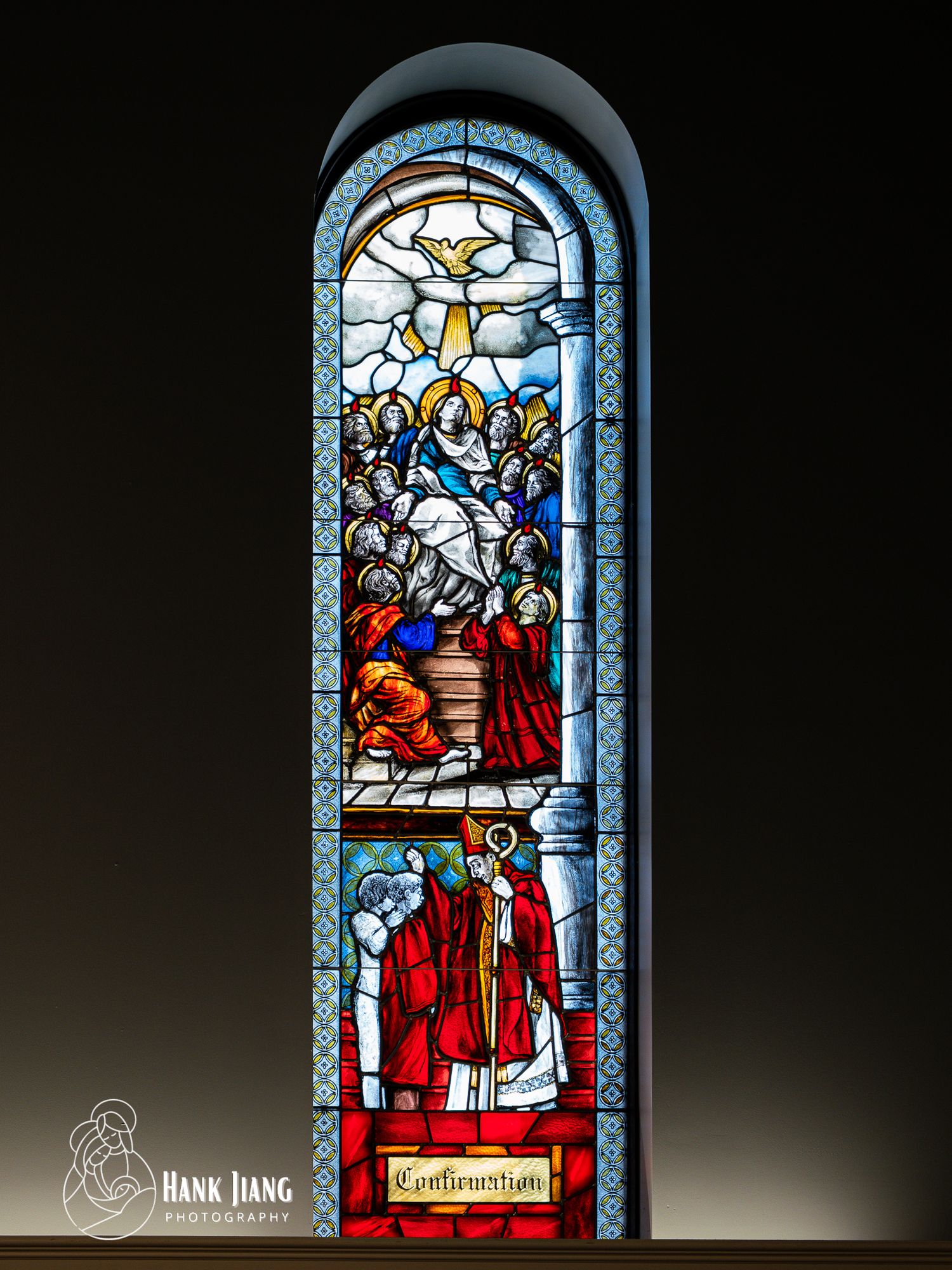 Stained glass church window depicting Confirmation sacrament with bishops, apostles, and Holy Spirit dove in vibrant colors.