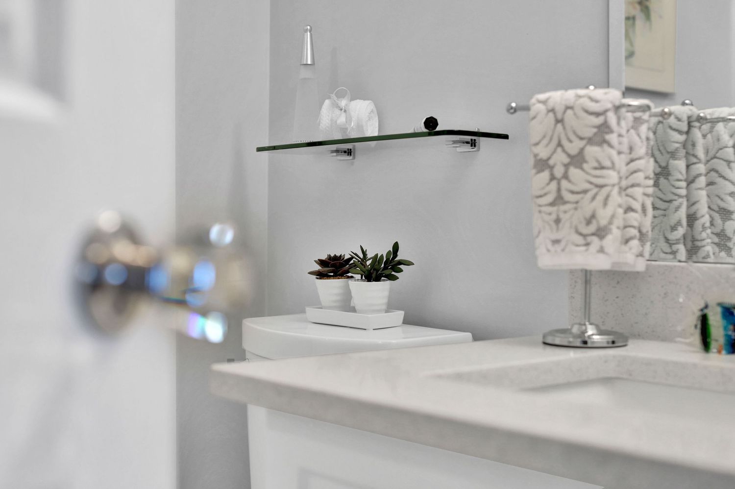 Elegant bathroom interior with marble countertops and modern fixtures.