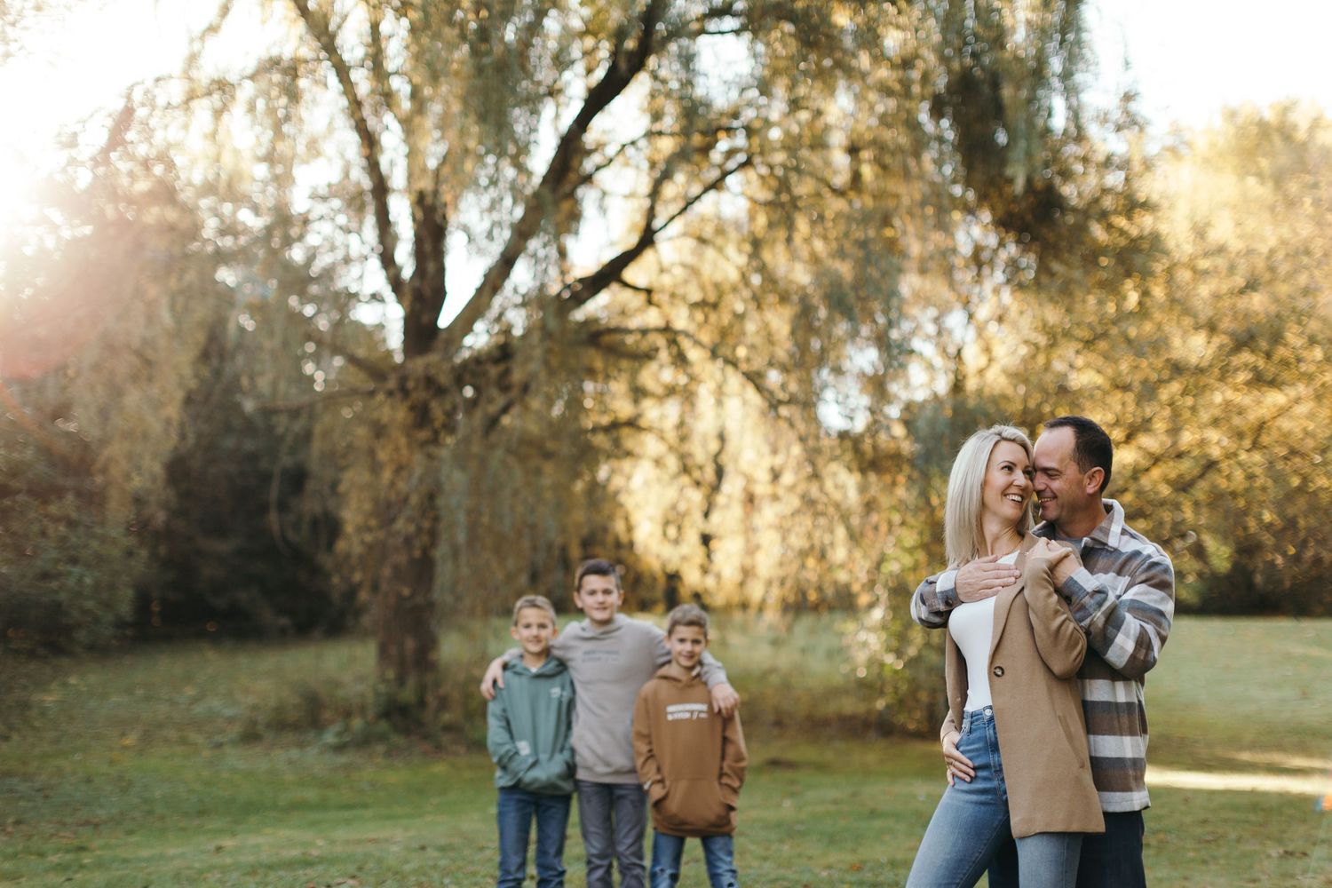 Family walking together during golden hour in a natural outdoor setting.