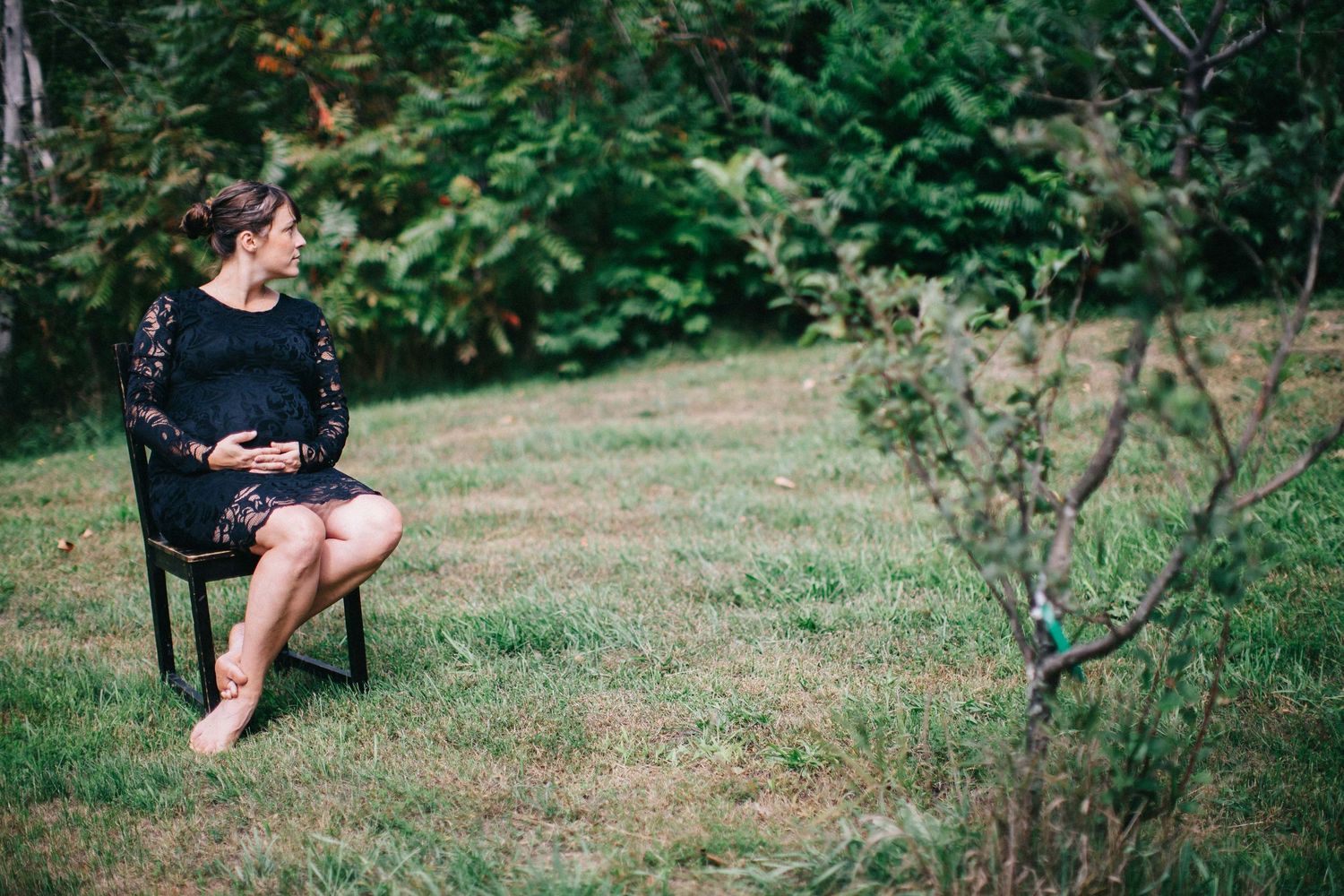 Casual outdoor family photography session in a green garden setting.