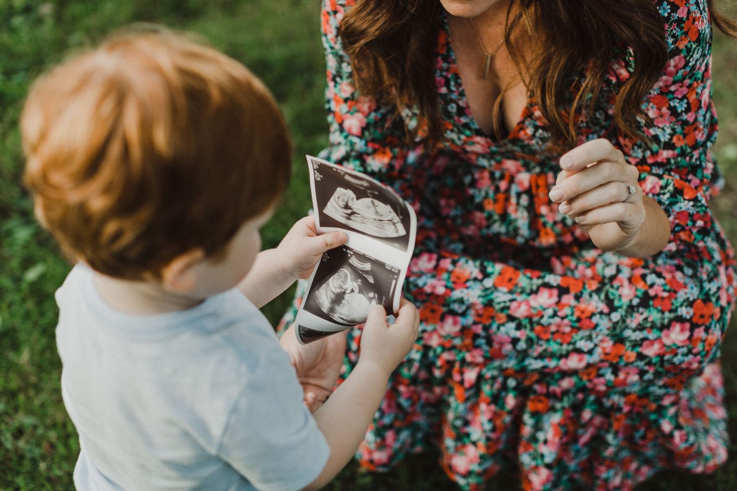 Candid outdoor family moments captured in spring with floral dress details.