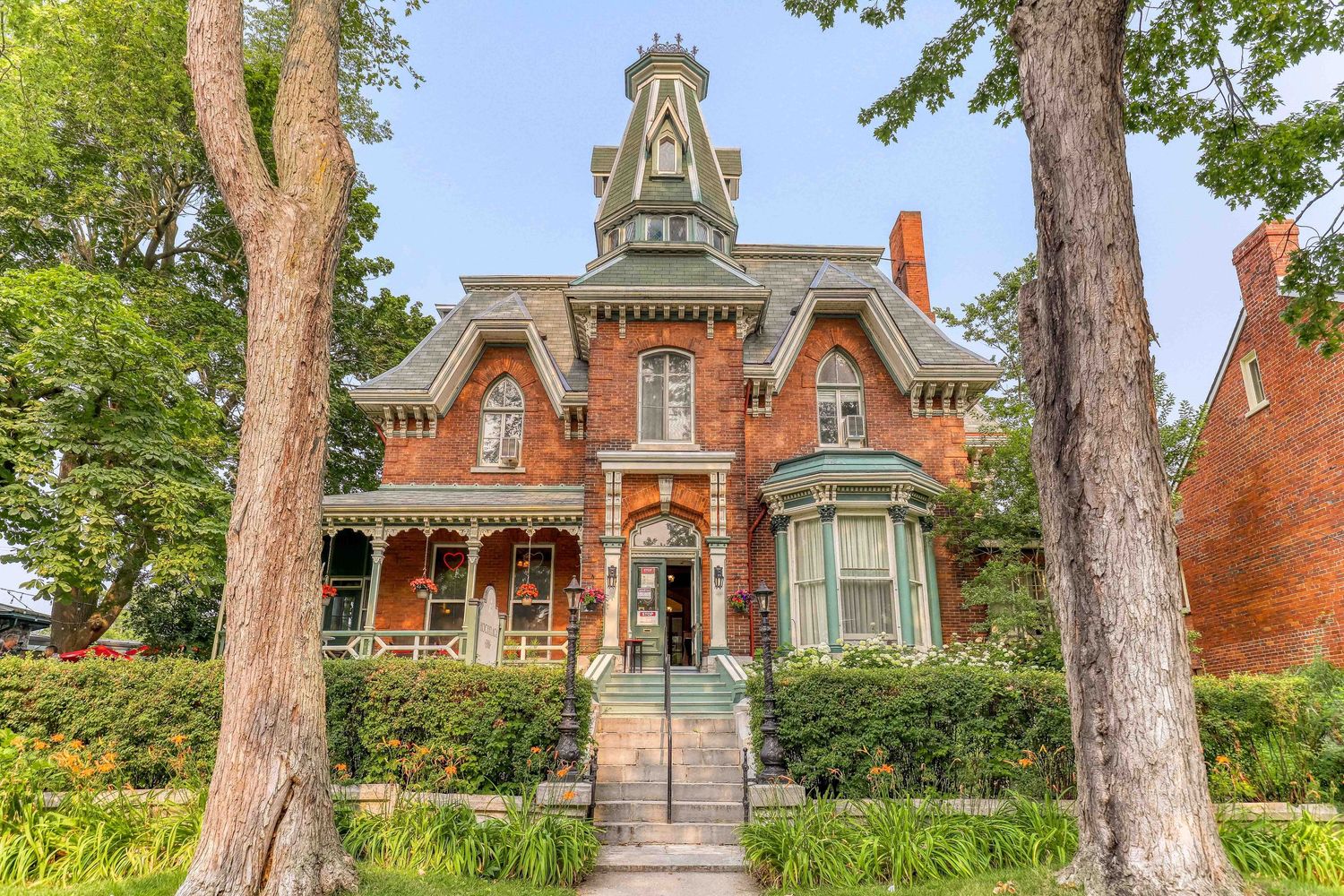 Historic Victorian mansion with red brick exterior and ornate architectural details.