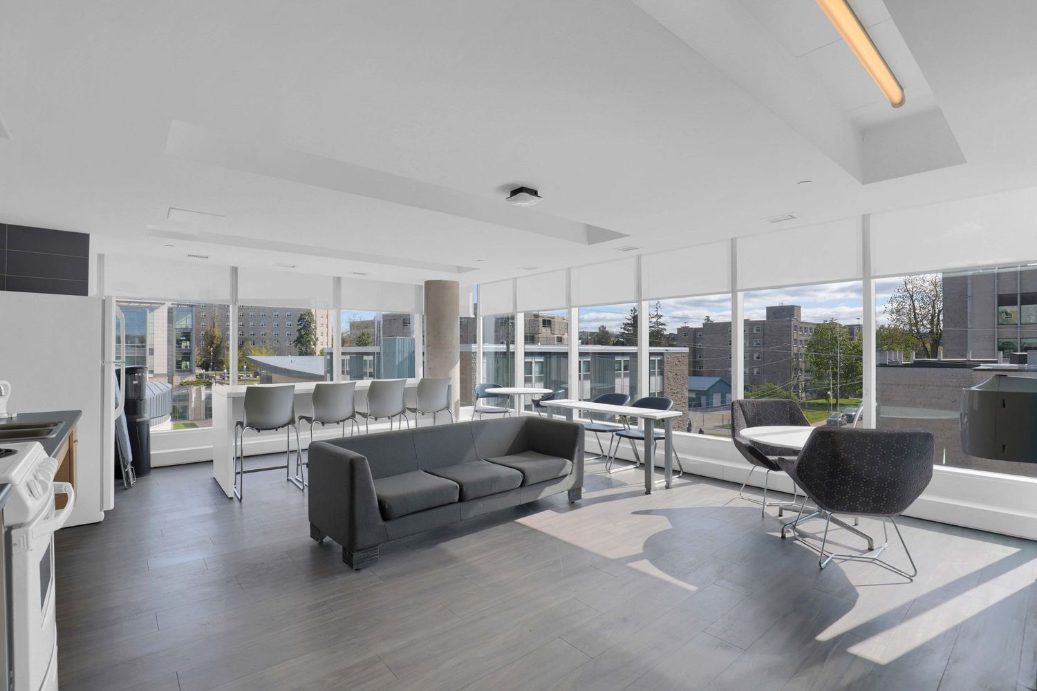Contemporary open concept office with large windows and modern furniture.