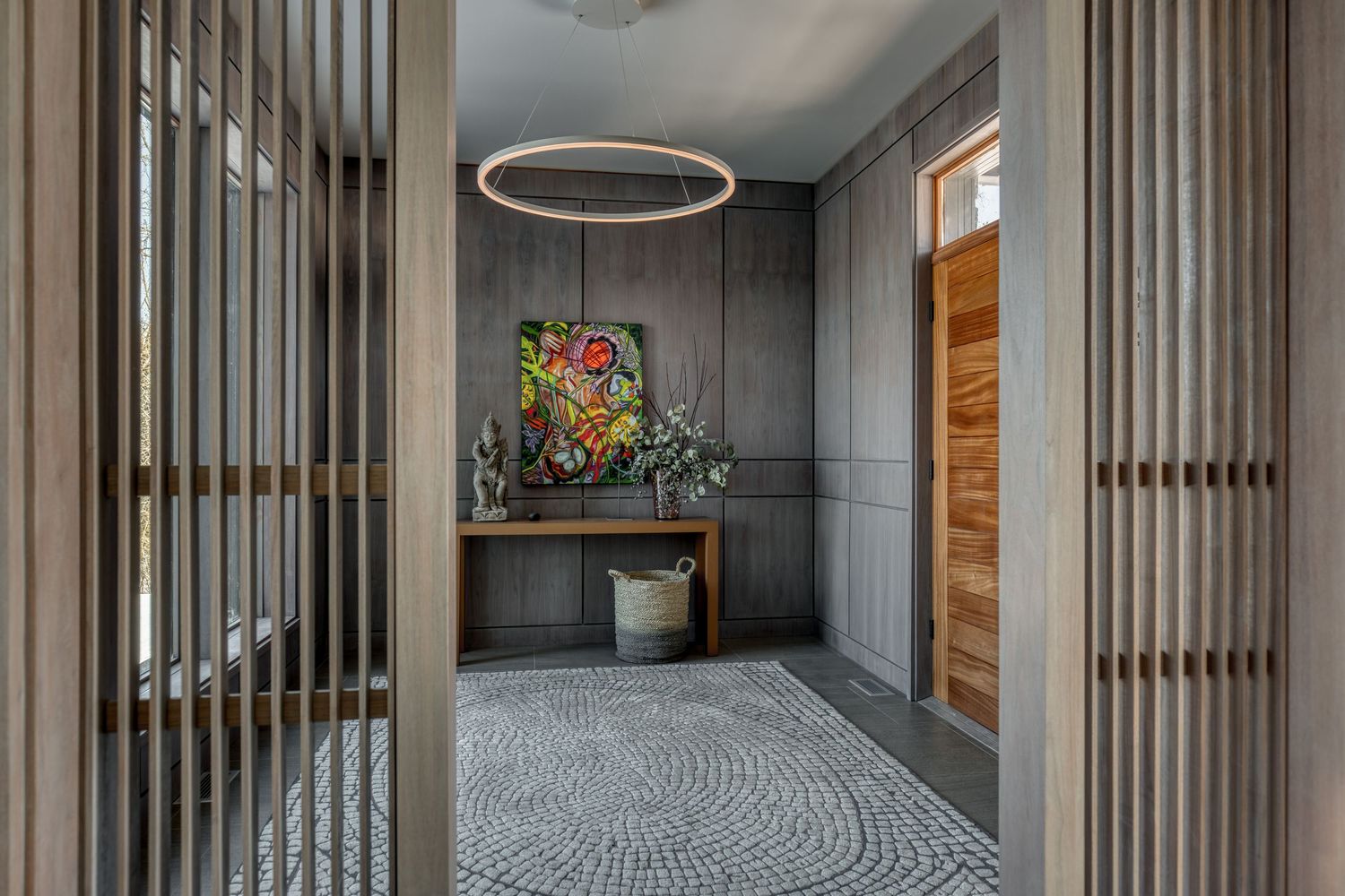 Modern hallway interior with circular lighting fixture and geometric patterns.