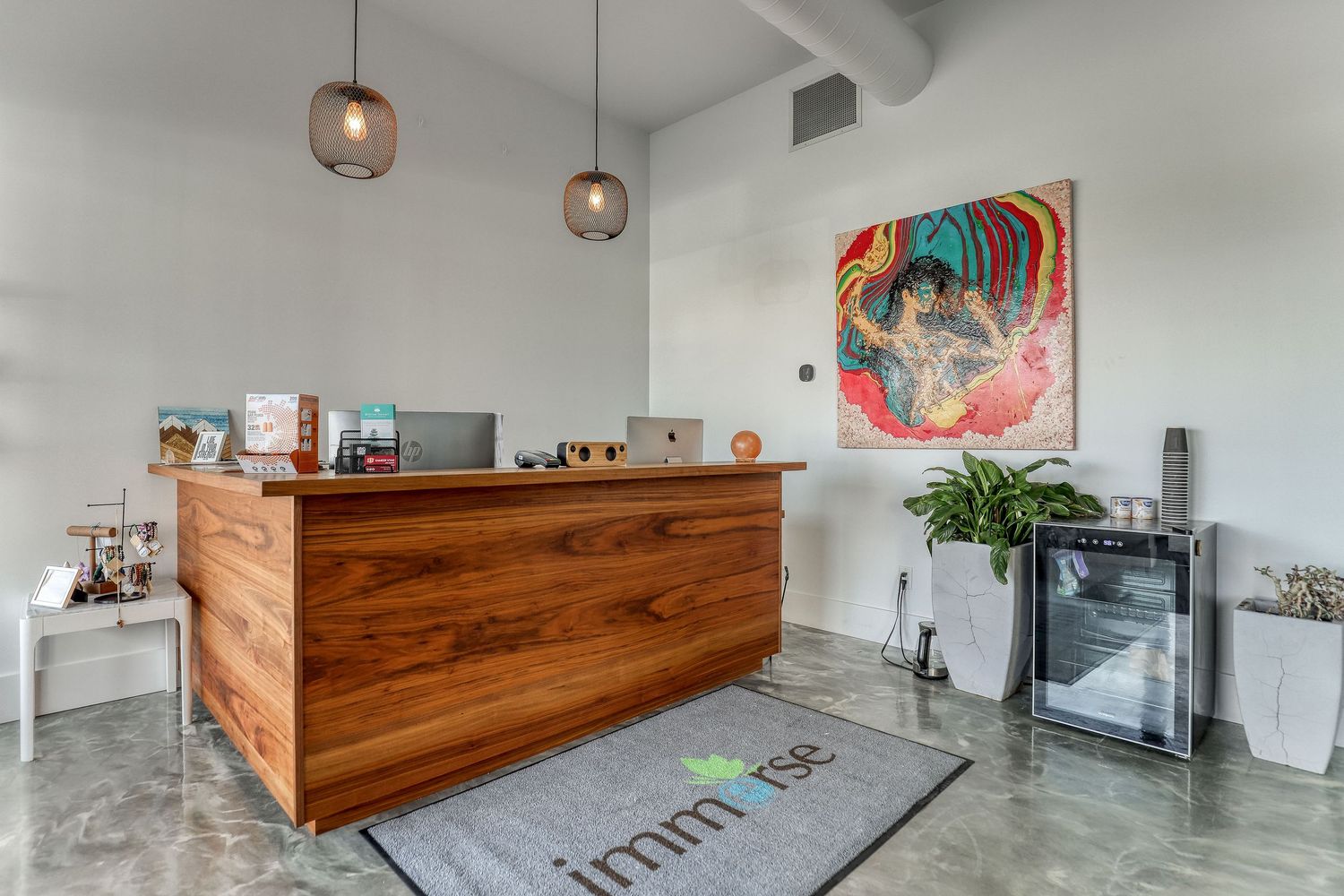 Modern office interior with wooden reception desk and minimalist decor.