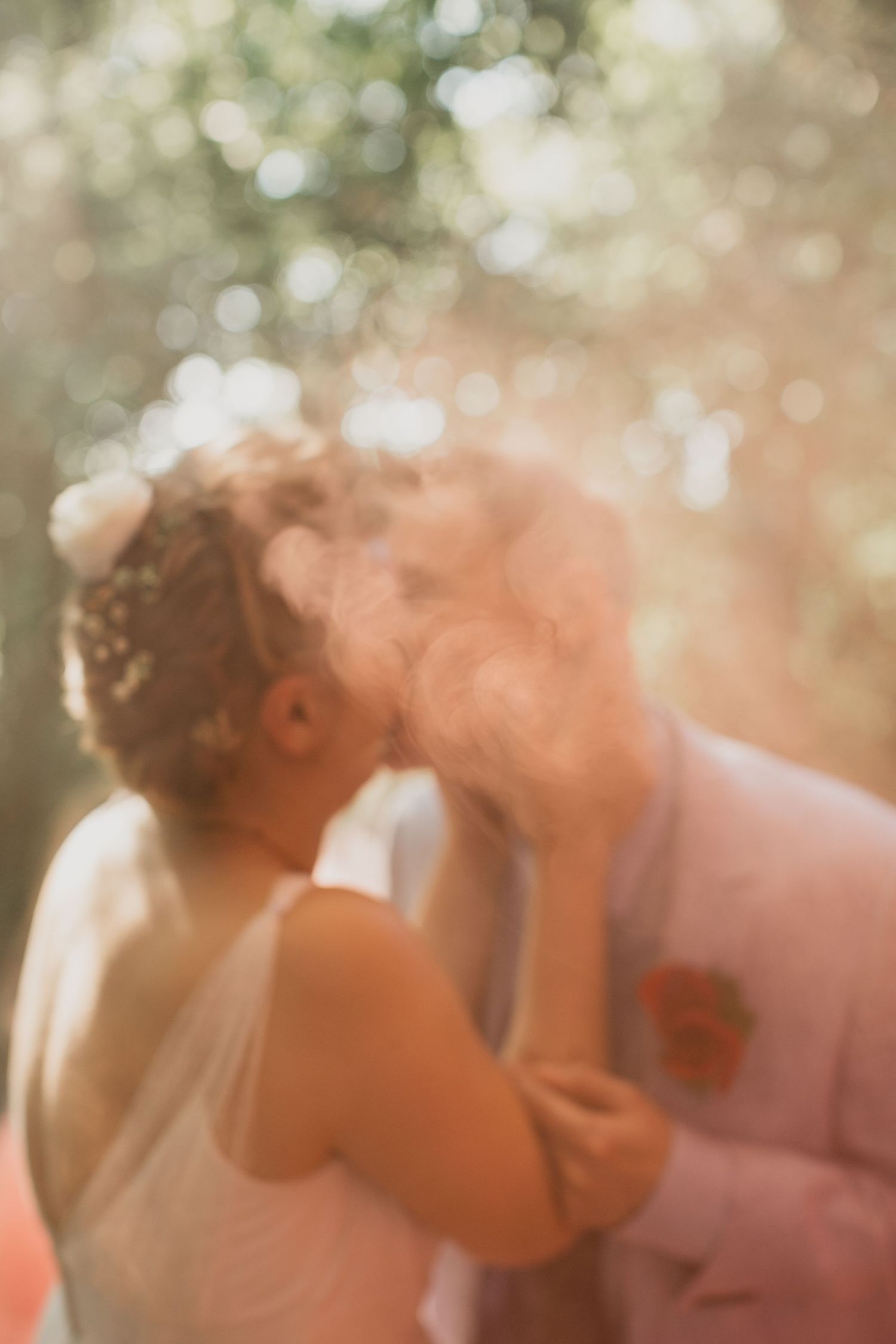 A dreamy sun-drenched wedding portrait with soft bokeh effects.
