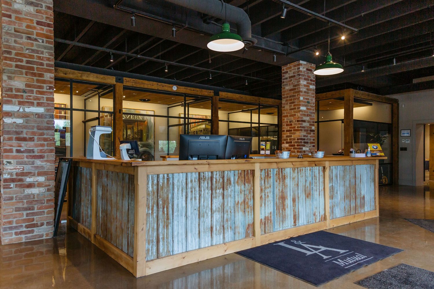 Industrial office space with exposed brick walls and wooden paneling.