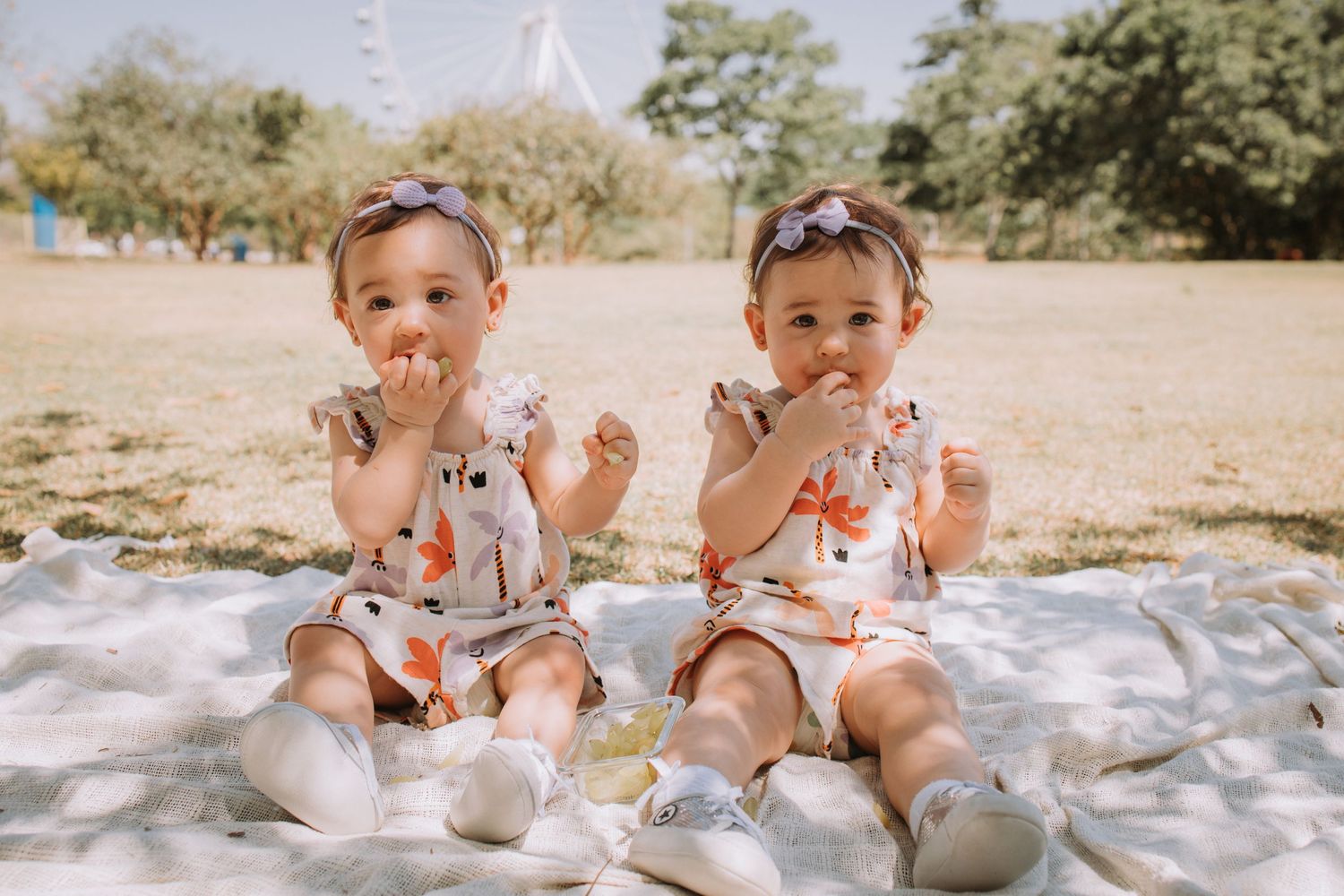 Children in white outfits having fun during an outdoor photoshoot.