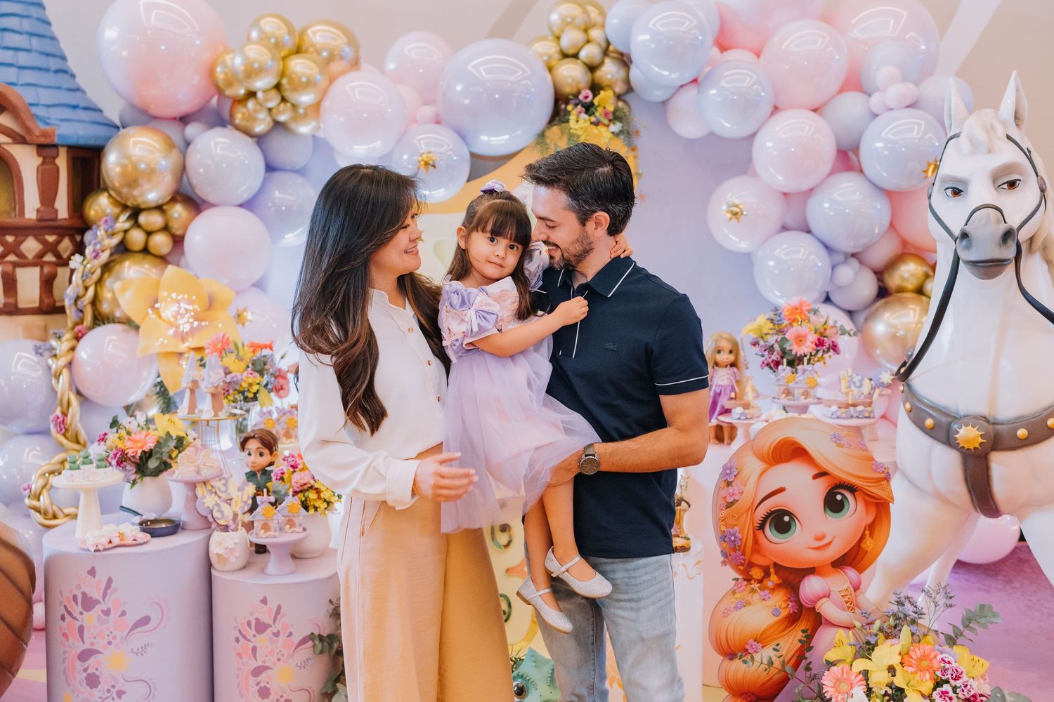 Birthday party decorations with pink and gold balloons creating a magical atmosphere.