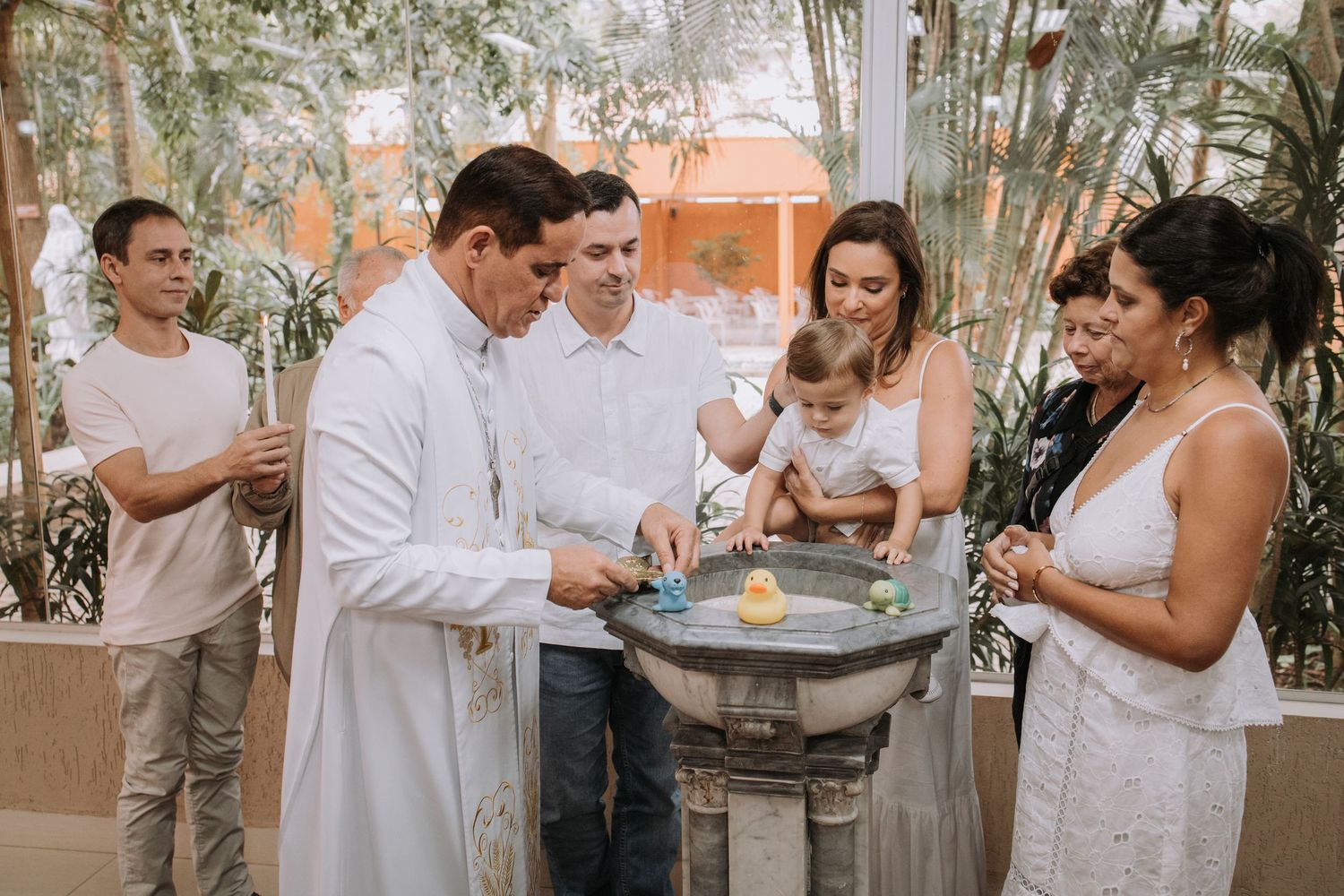 Family and friends gather around for a celebration in an elegant indoor venue.