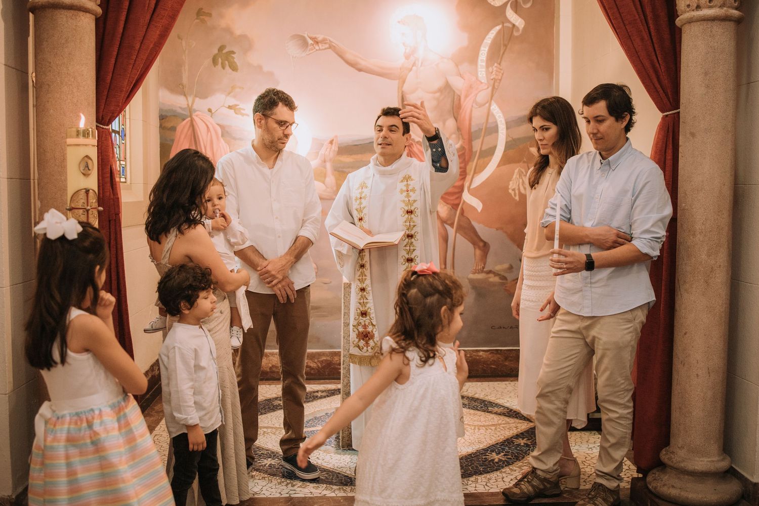 Guests mingling in a formal venue with classical architecture and warm lighting.