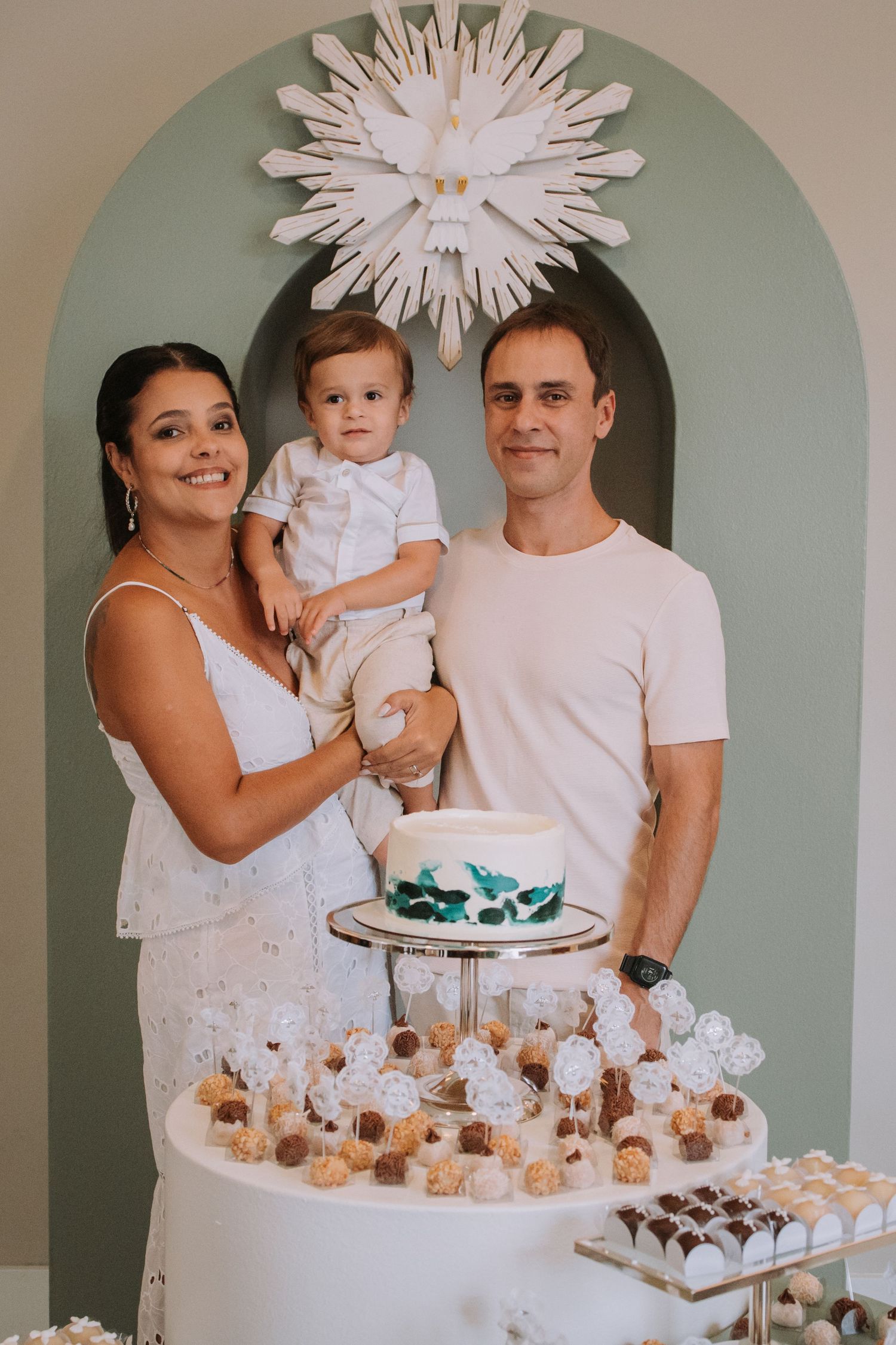 Elegant dessert display featuring white treats and decorative elements in an arched alcove.