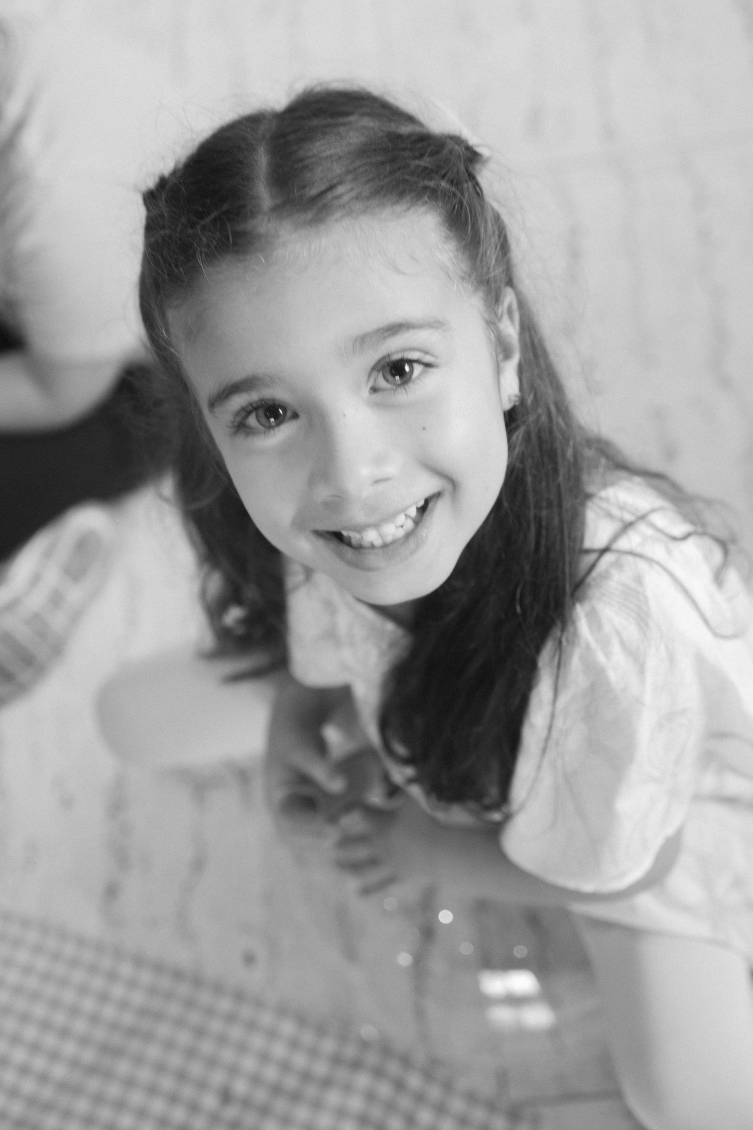 Black and white portrait series showing playful expressions and close-up angles.