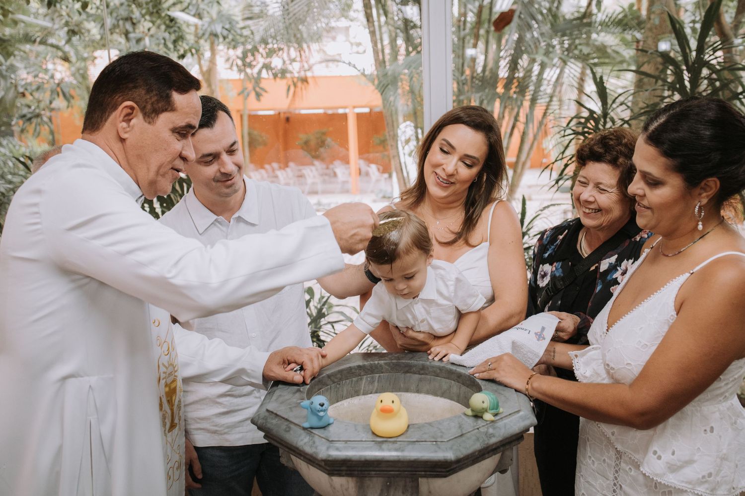Guests participate in a celebratory event around a decorative table setting.