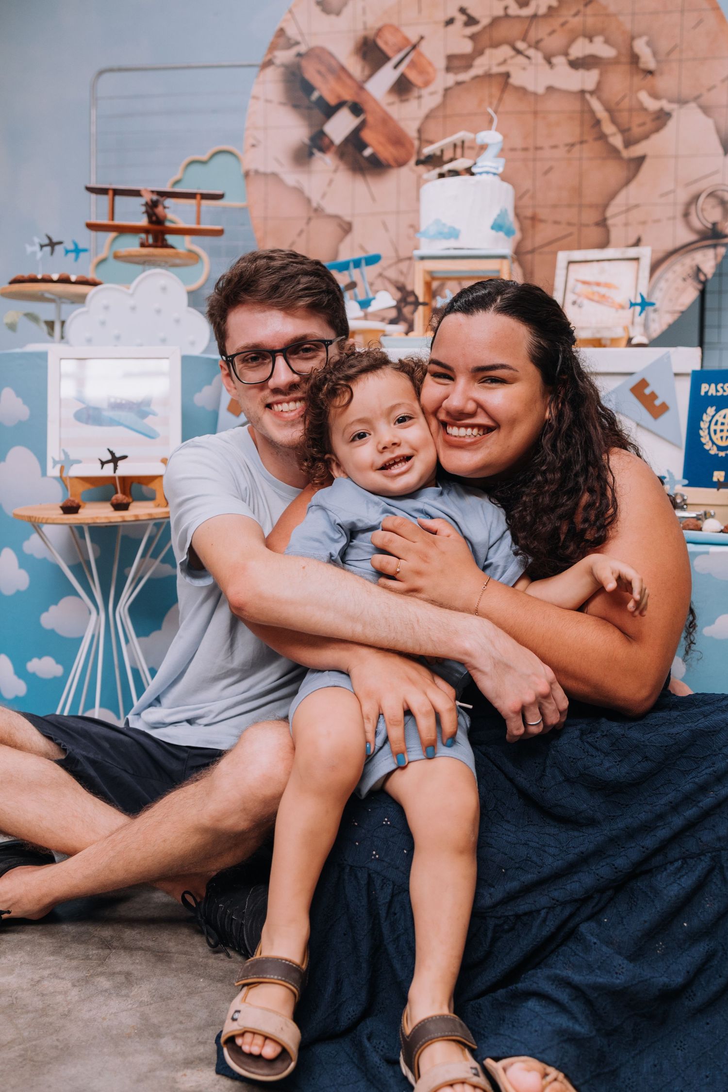 Family relaxing together in a room decorated with airplane themed wall art.