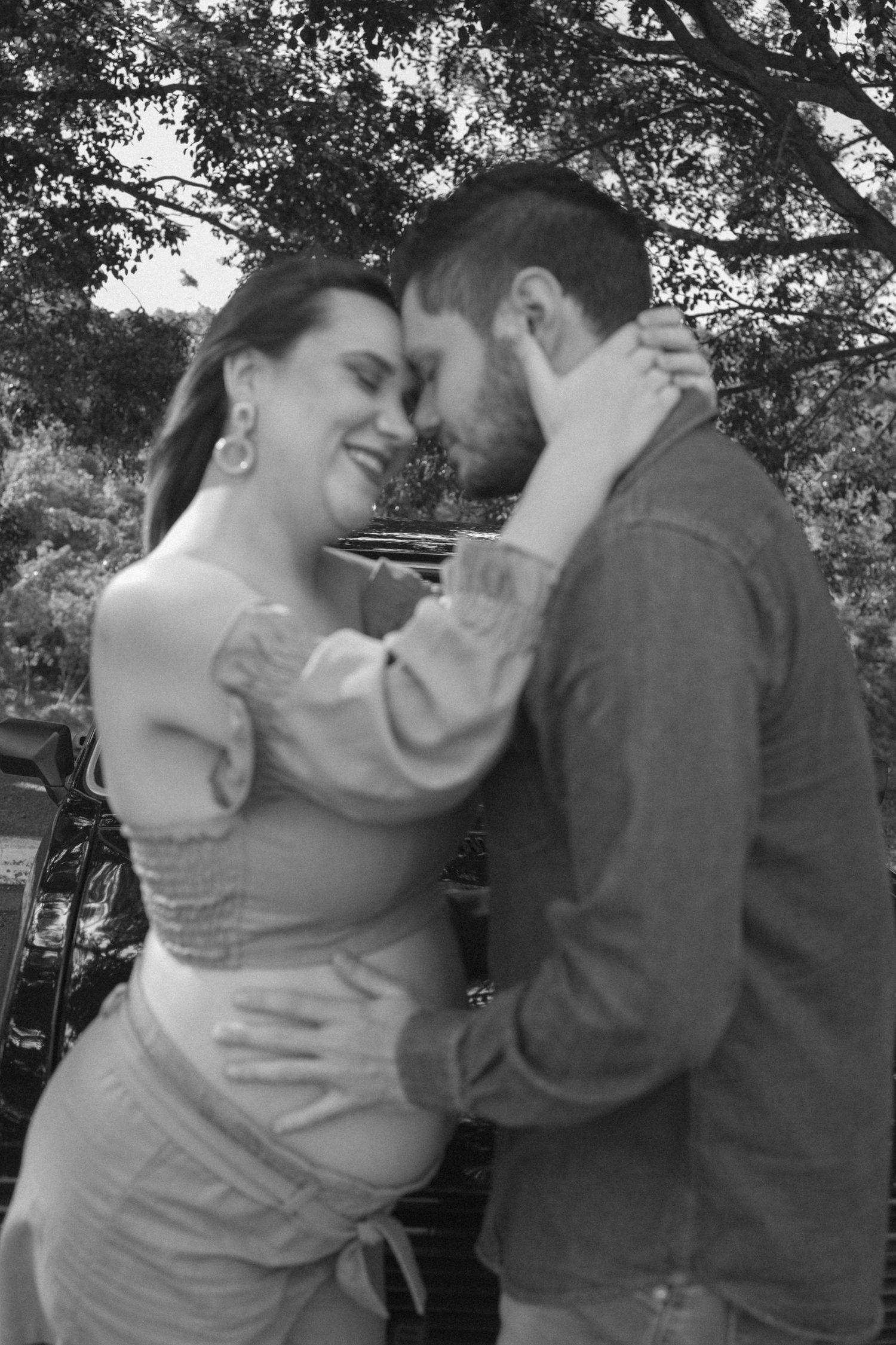 A couple shares a romantic dance sequence captured in black and white photography.