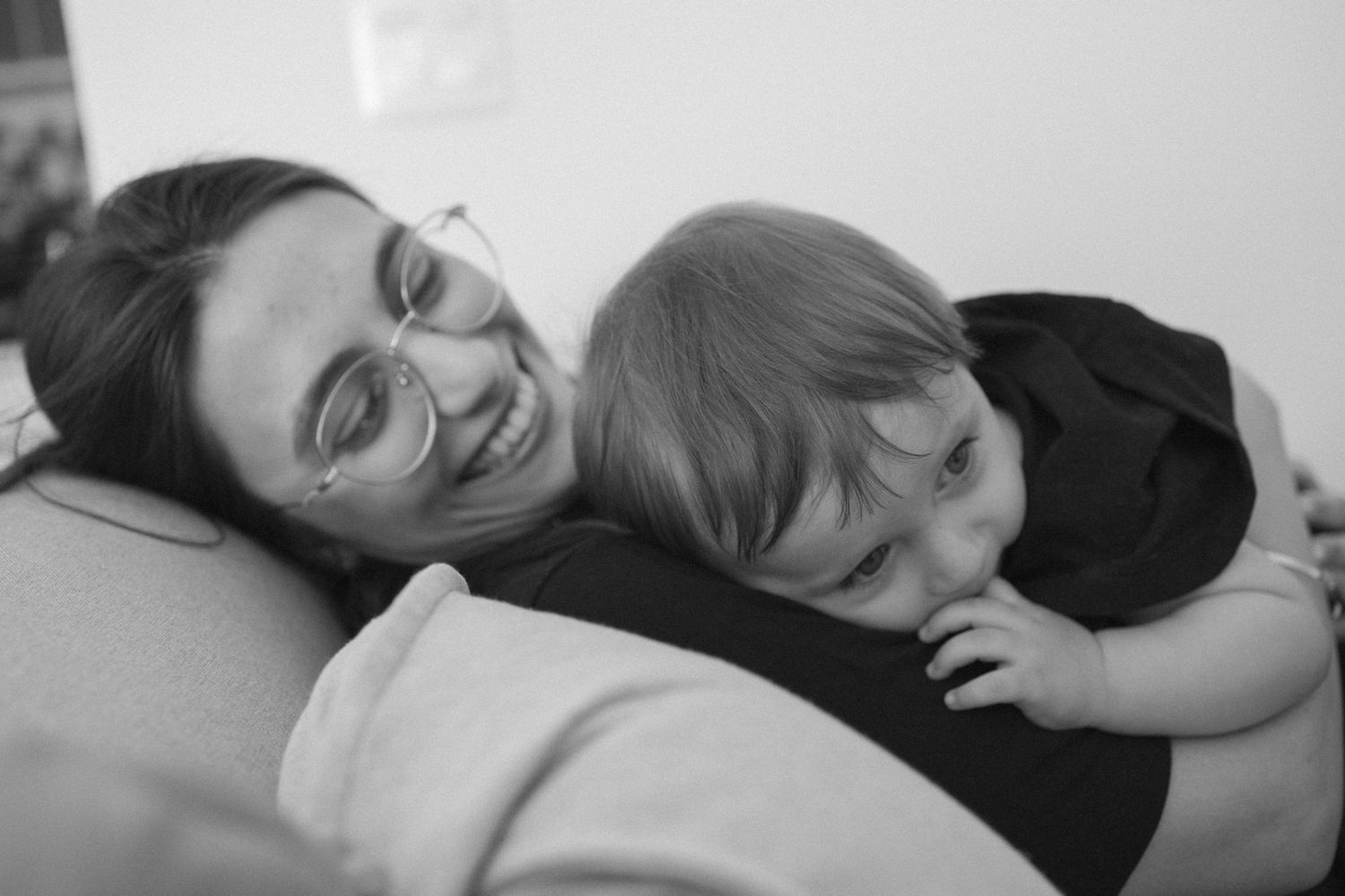 Intimate black and white photograph showing restful moments on a bed.