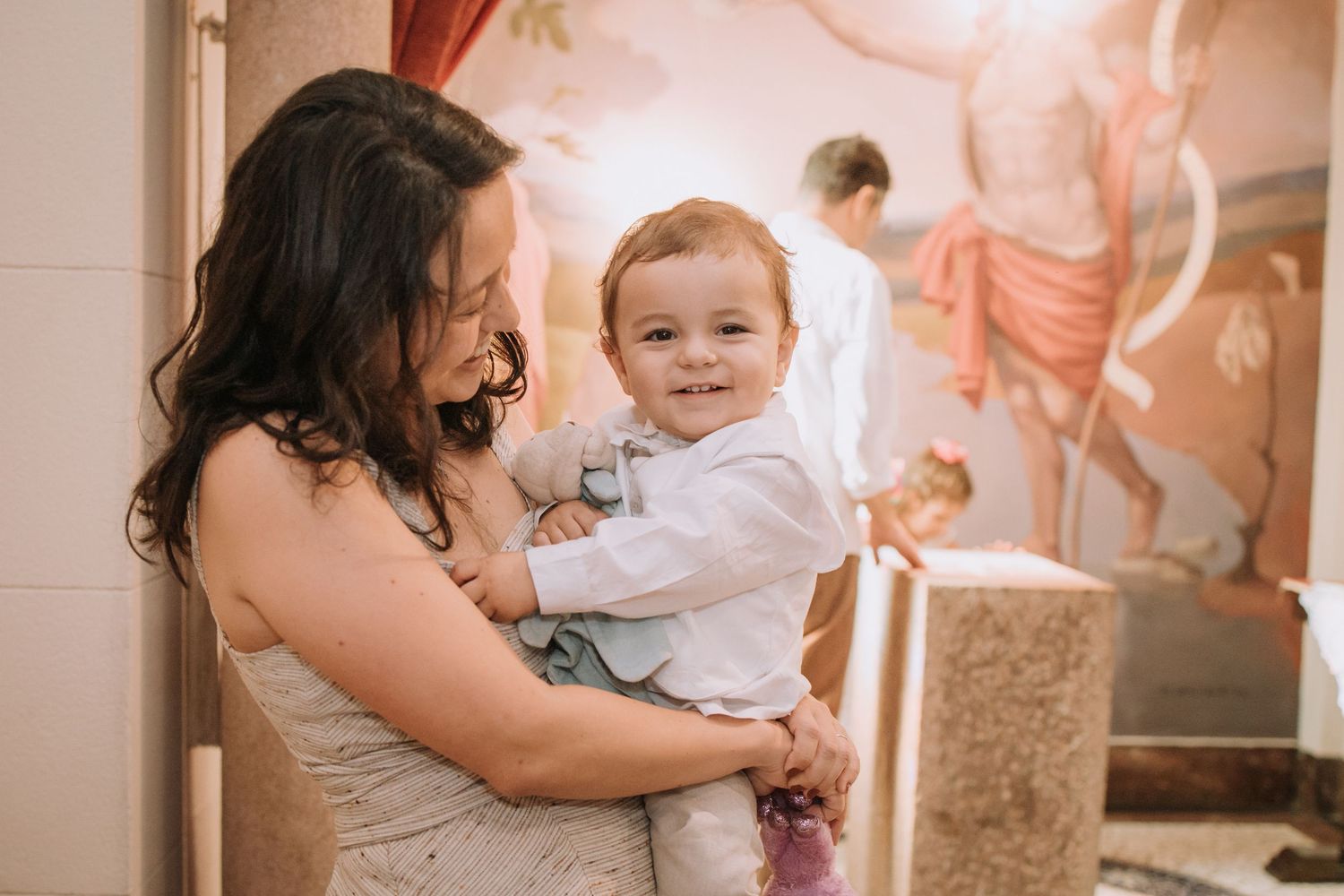 Warm-toned celebration photos in an elegant venue with columns and curtains.