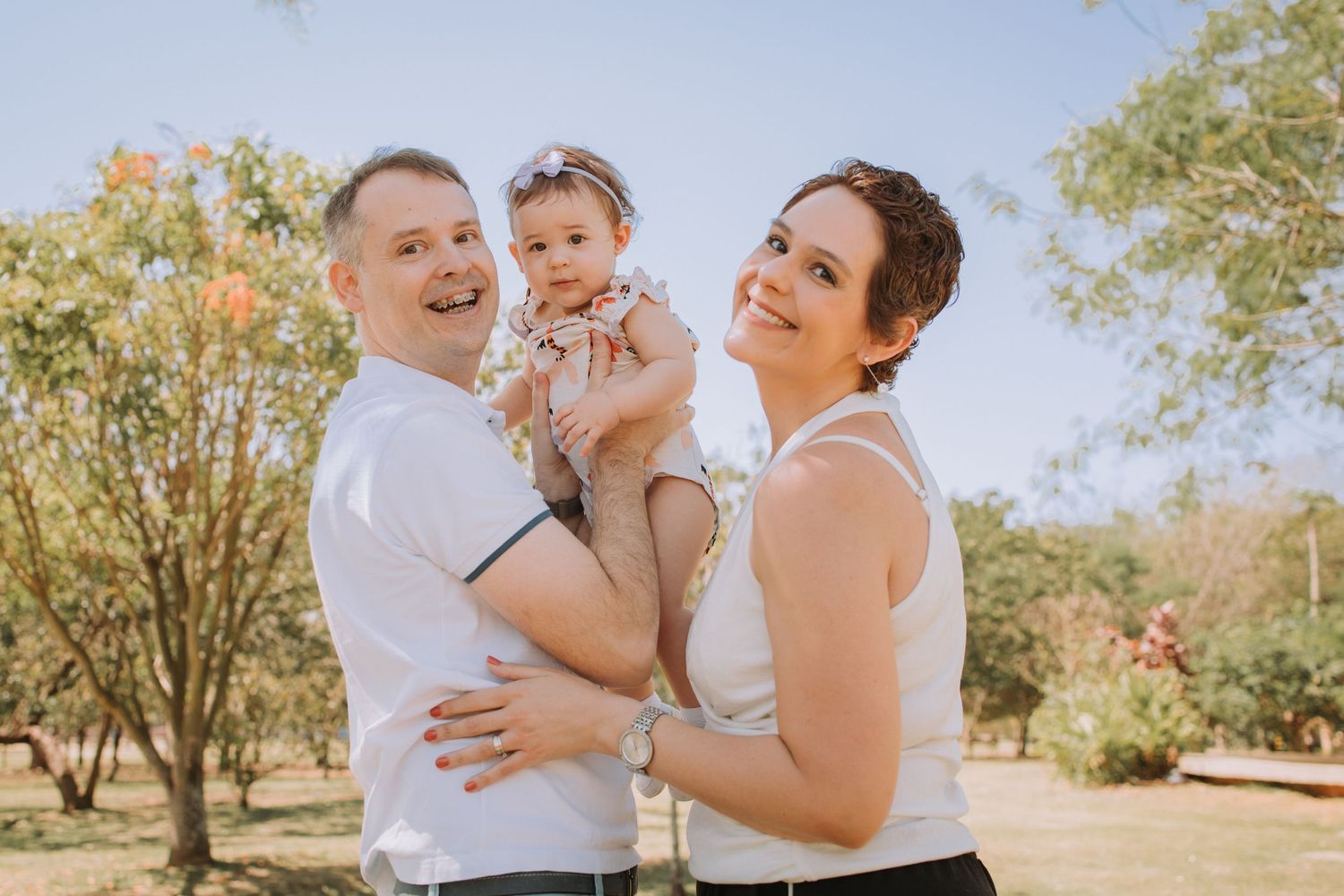 A series of candid family portraits showing loving interactions in a park setting.