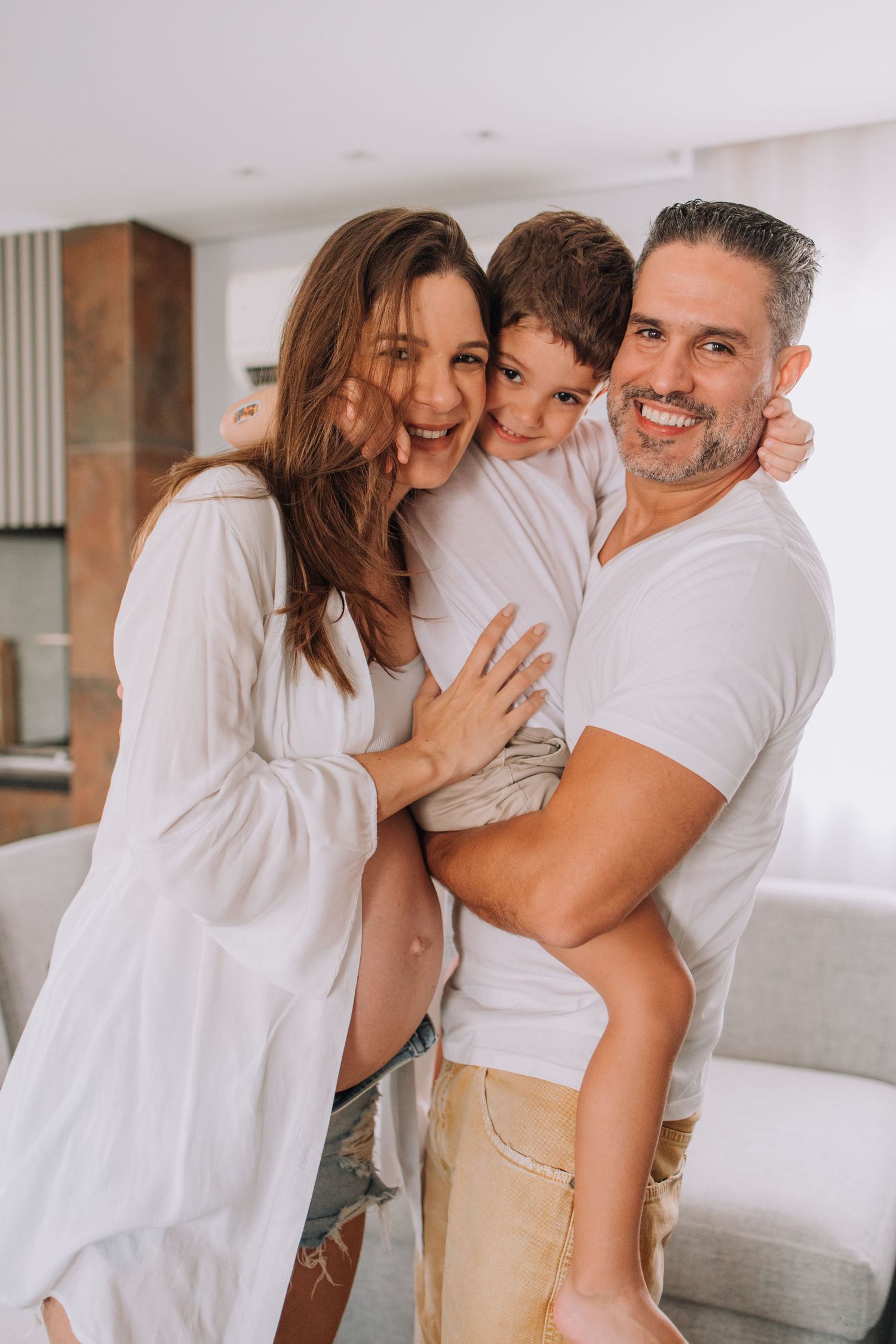 Happy family shares joyful moment together in bright modern living space.