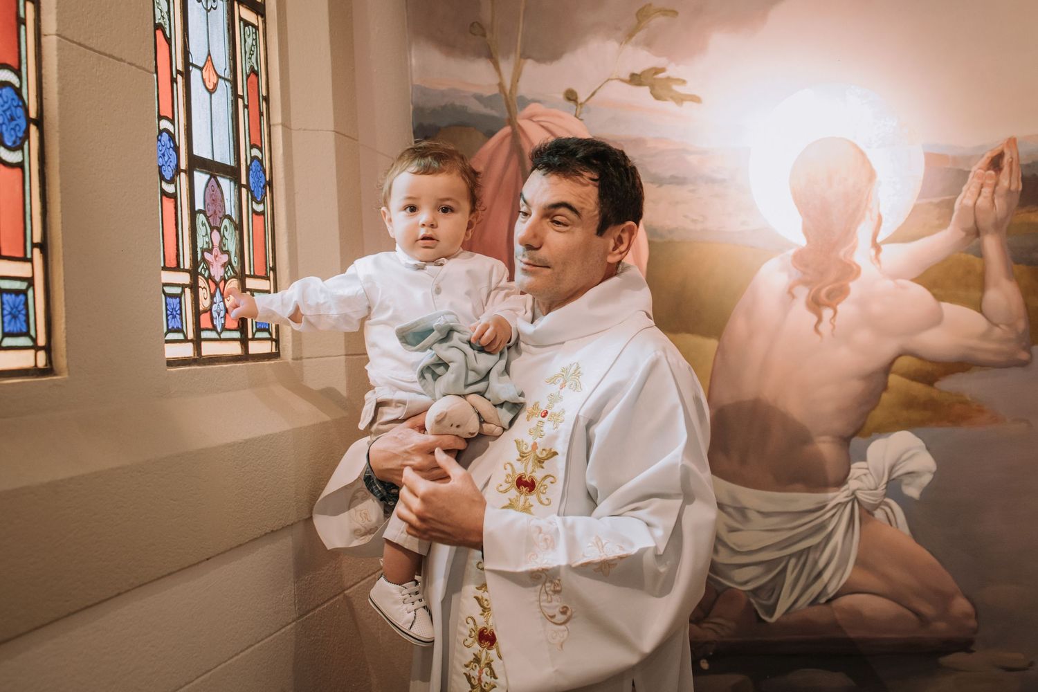 Celebration photos in a church setting with stained glass windows and natural light.
