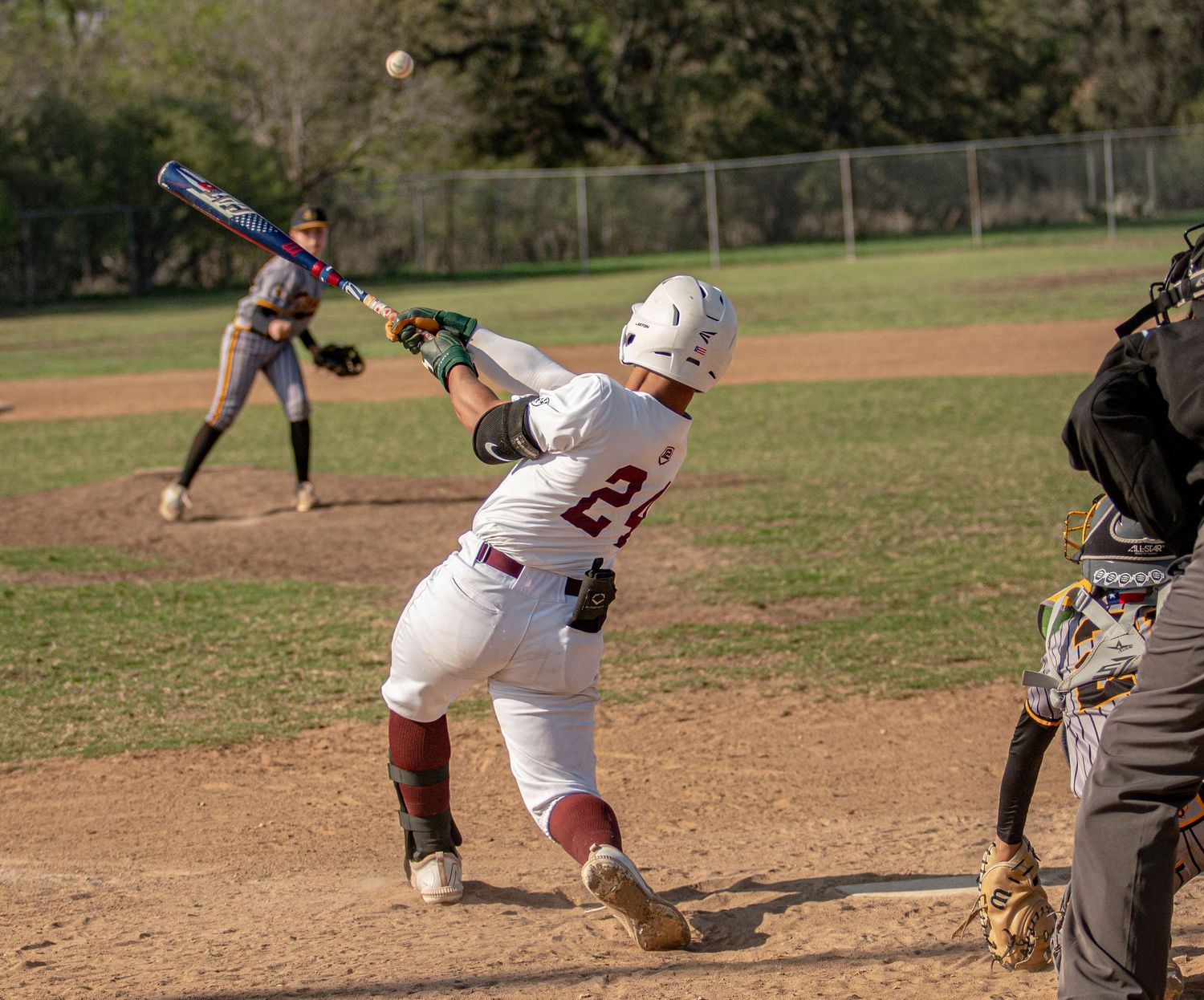 Baseball action shots showing batter's stance and swing sequence on dirt infield.