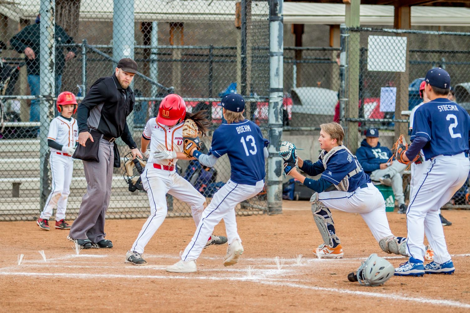 Multiple baseball players sliding into home plate during various game situations.