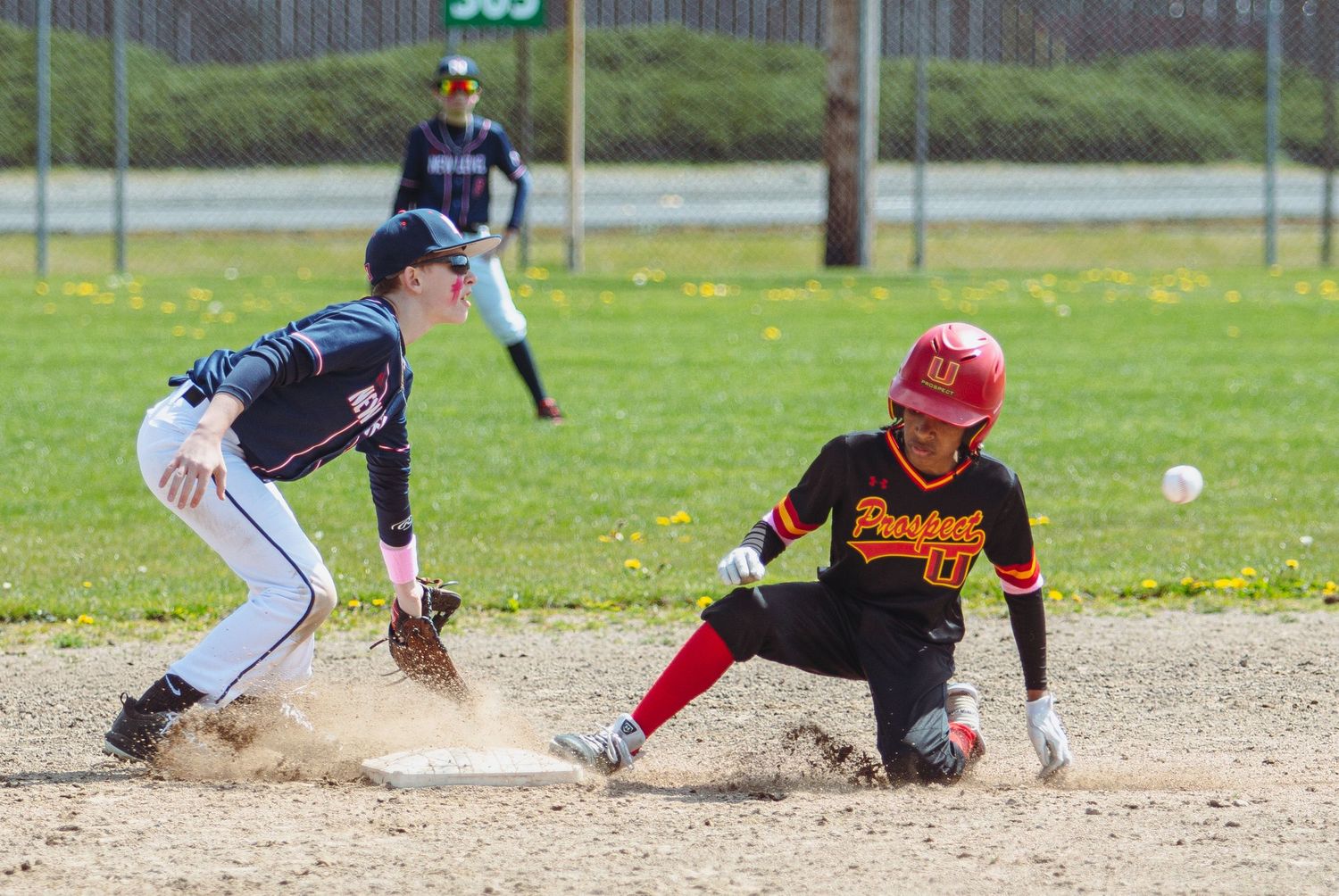 Players compete for position during a close play at second base.
