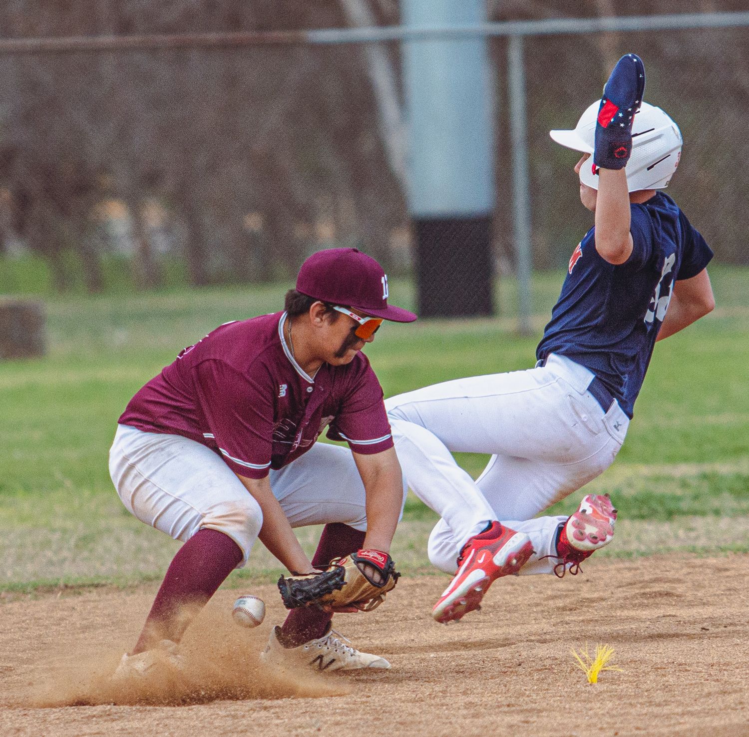 Baseball players diving and sliding into bases during an intense game sequence.