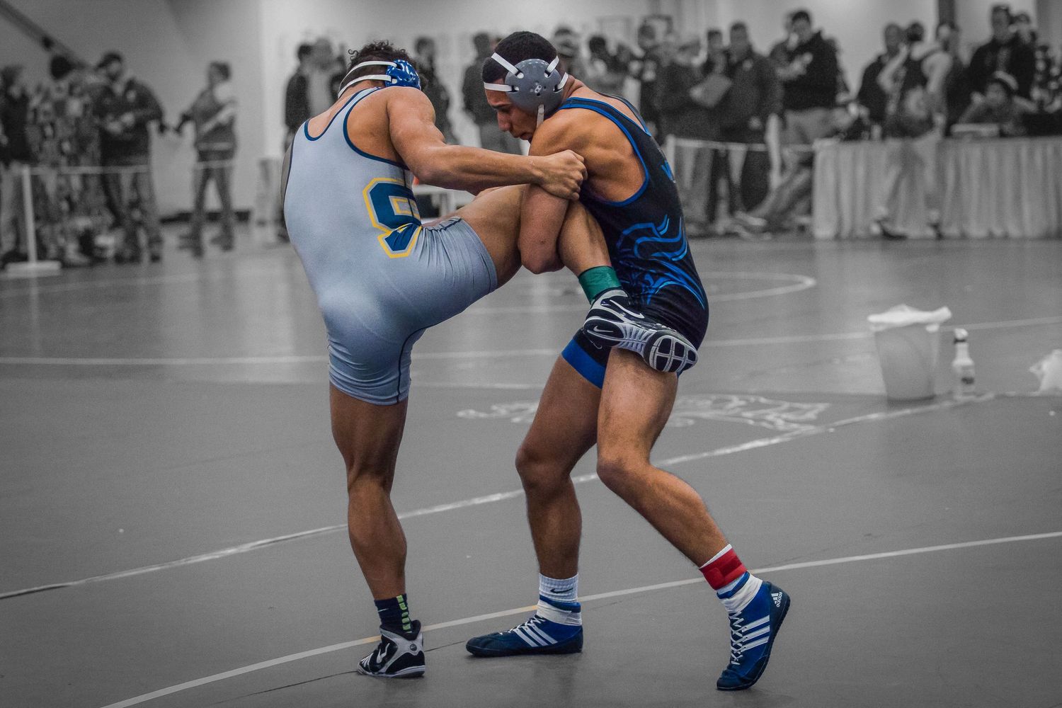Wrestlers showcase their skills during a competitive match on the mat.