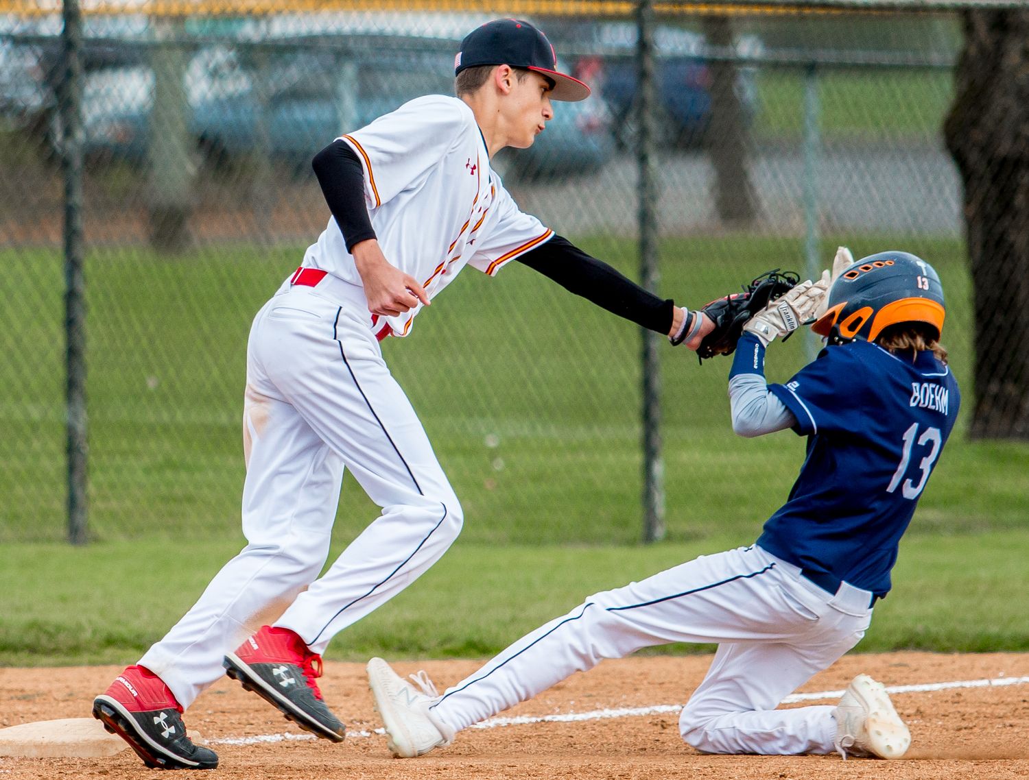 Baseball players sliding and tagging bases during game plays.