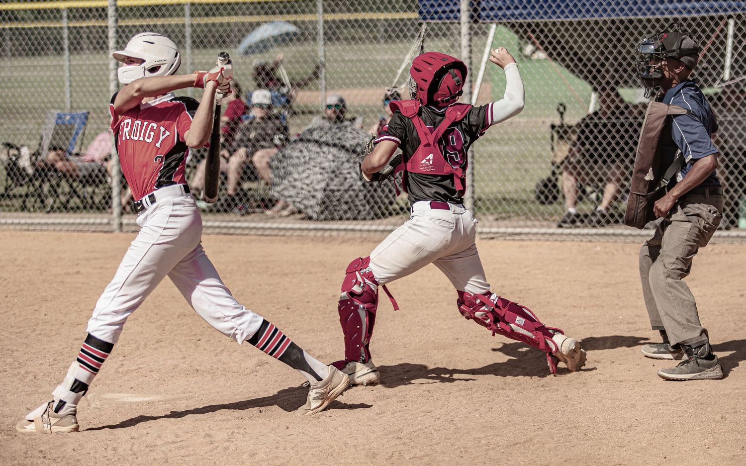 Baseball action at home plate between batter and catcher during game.