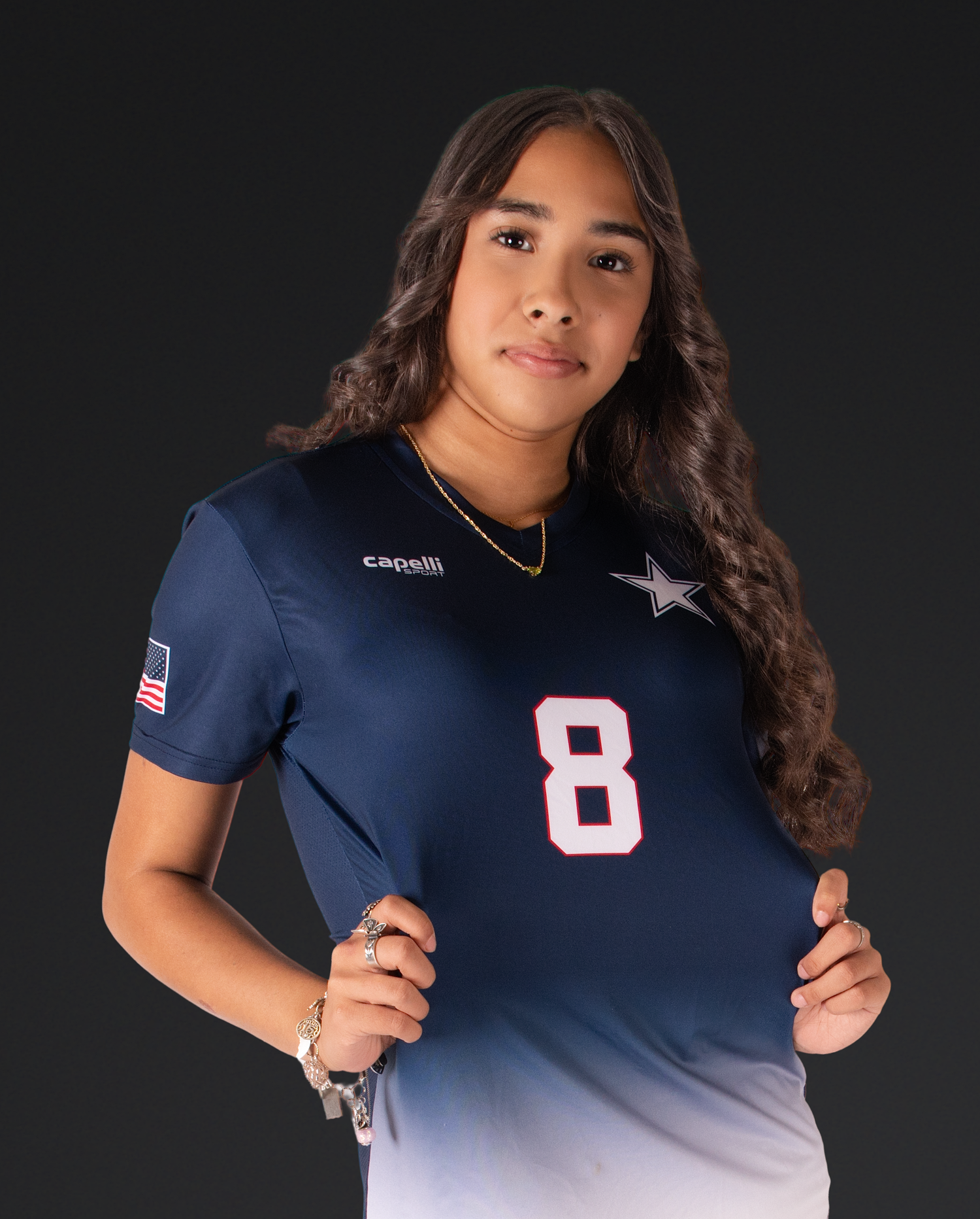Player wearing navy ombre jersey number 8 poses for sports portrait.