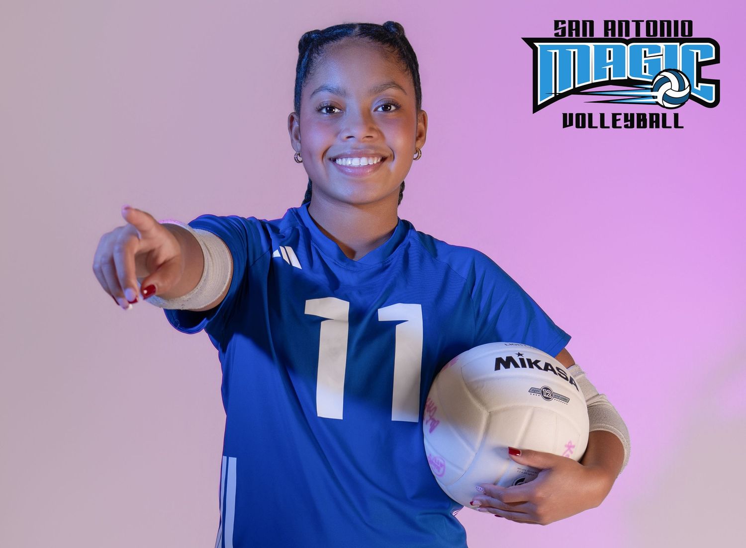 Volleyball athlete in blue uniform shows energetic poses during studio photoshoot.