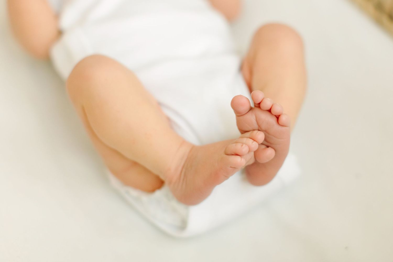 Close up of tiny baby feet against white background at White Space Studios in Provo, Utah in Utah County..