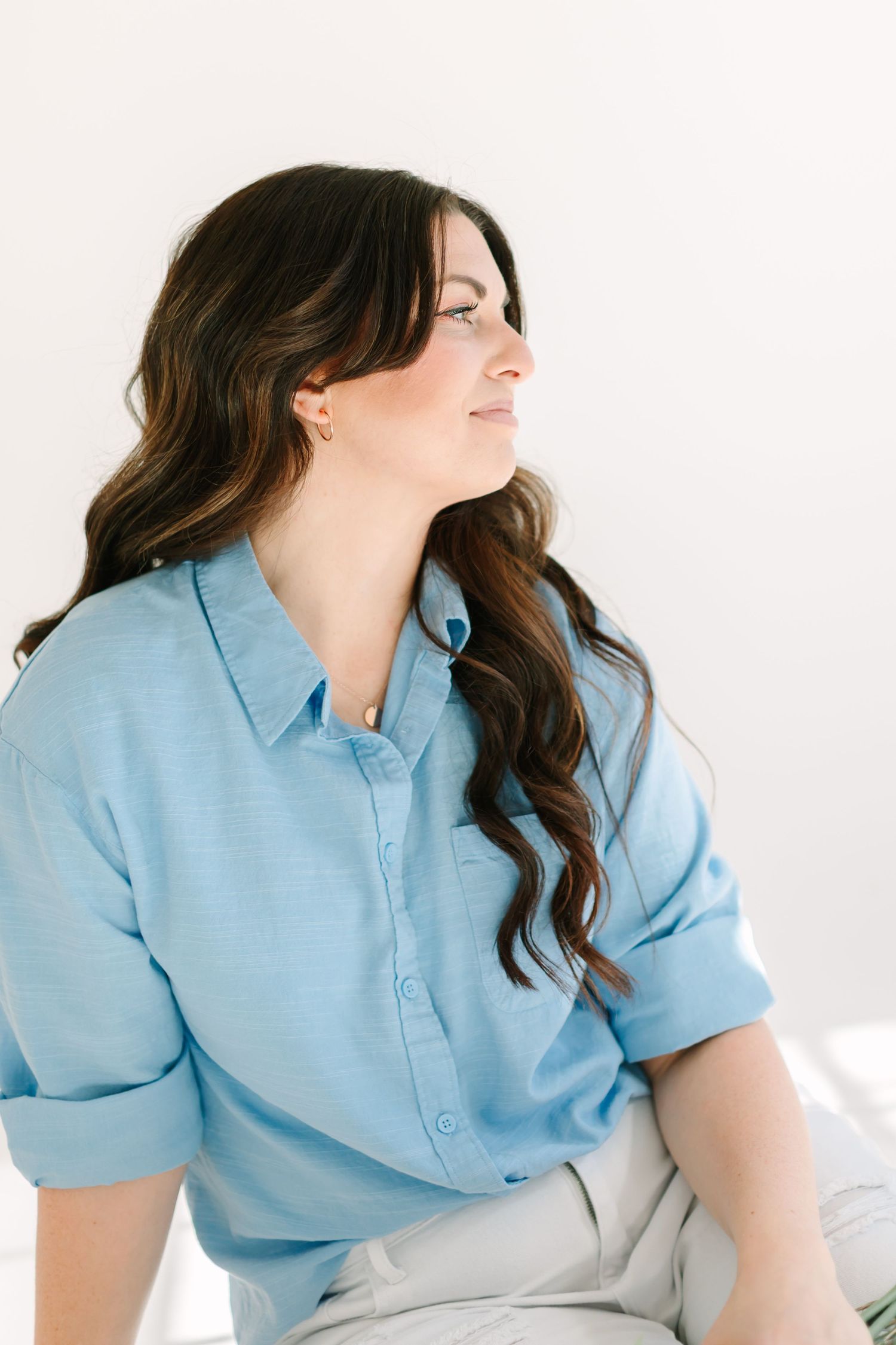 A person wearing a light blue collared shirt poses against a white background in a dynamic three-panel sequence.