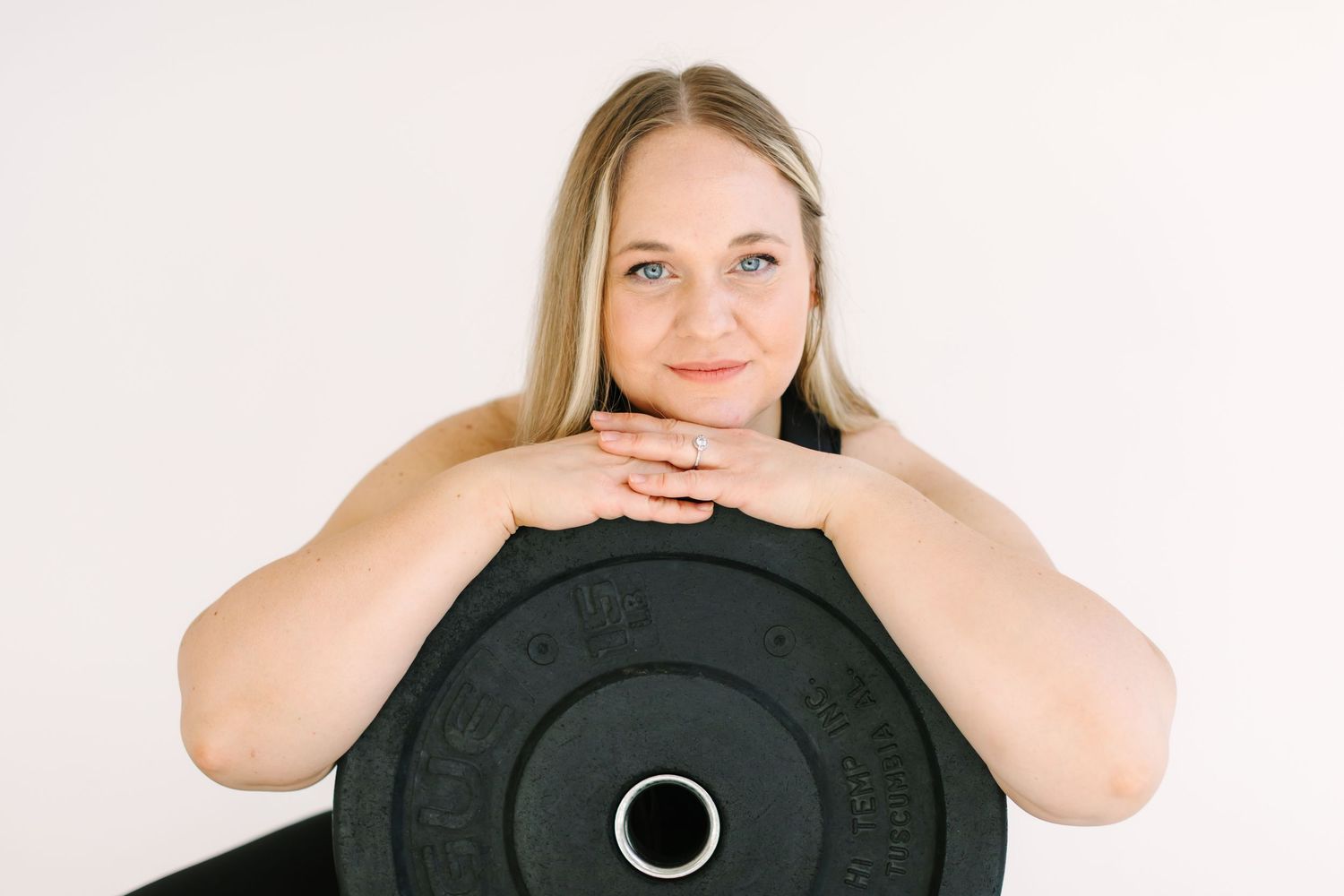 A sequence of four photos showing someone posing with a camera lens against a white background.