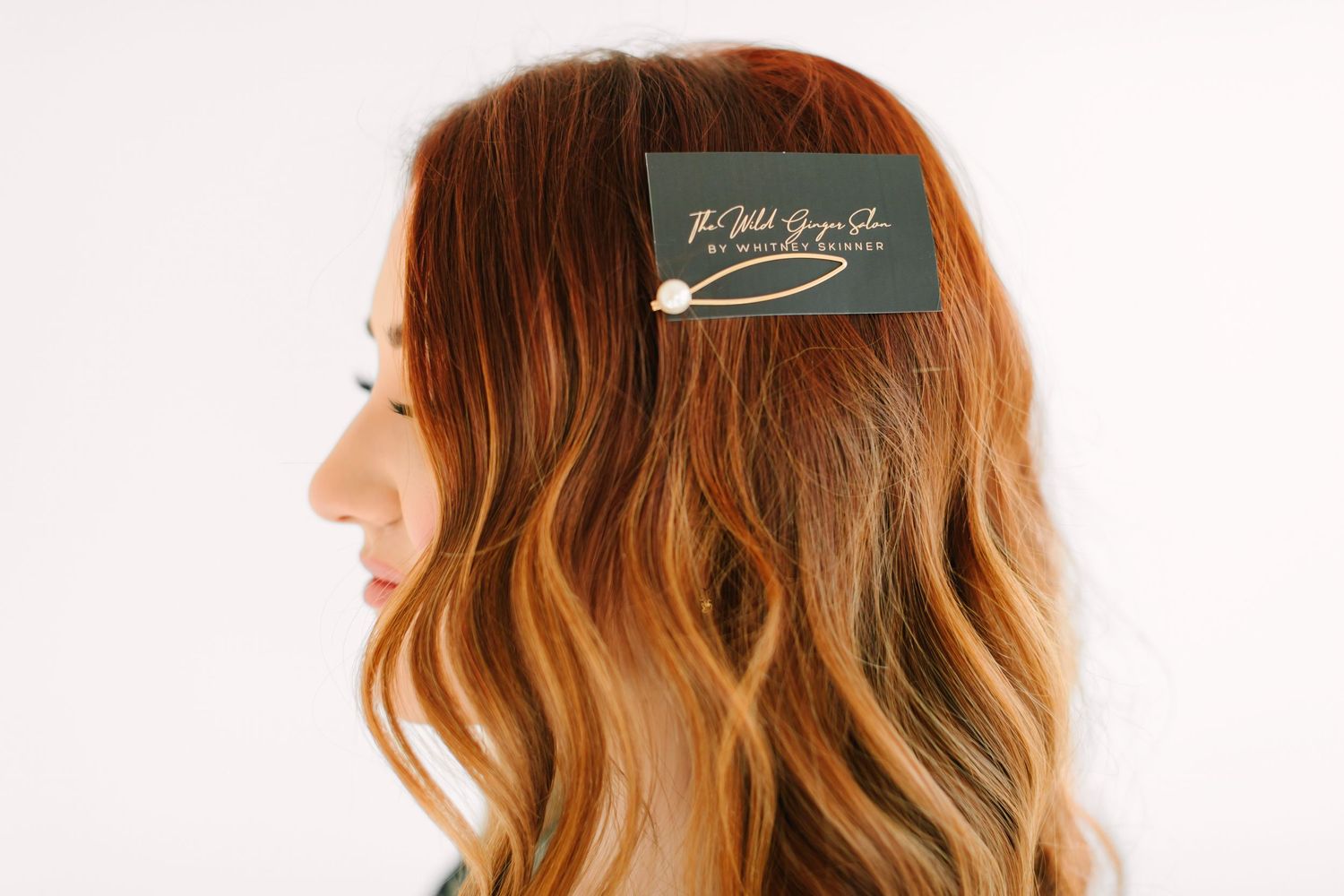 Woman with long wavy ombre hair showing natural balayage highlights in warm honey tones from side angles.