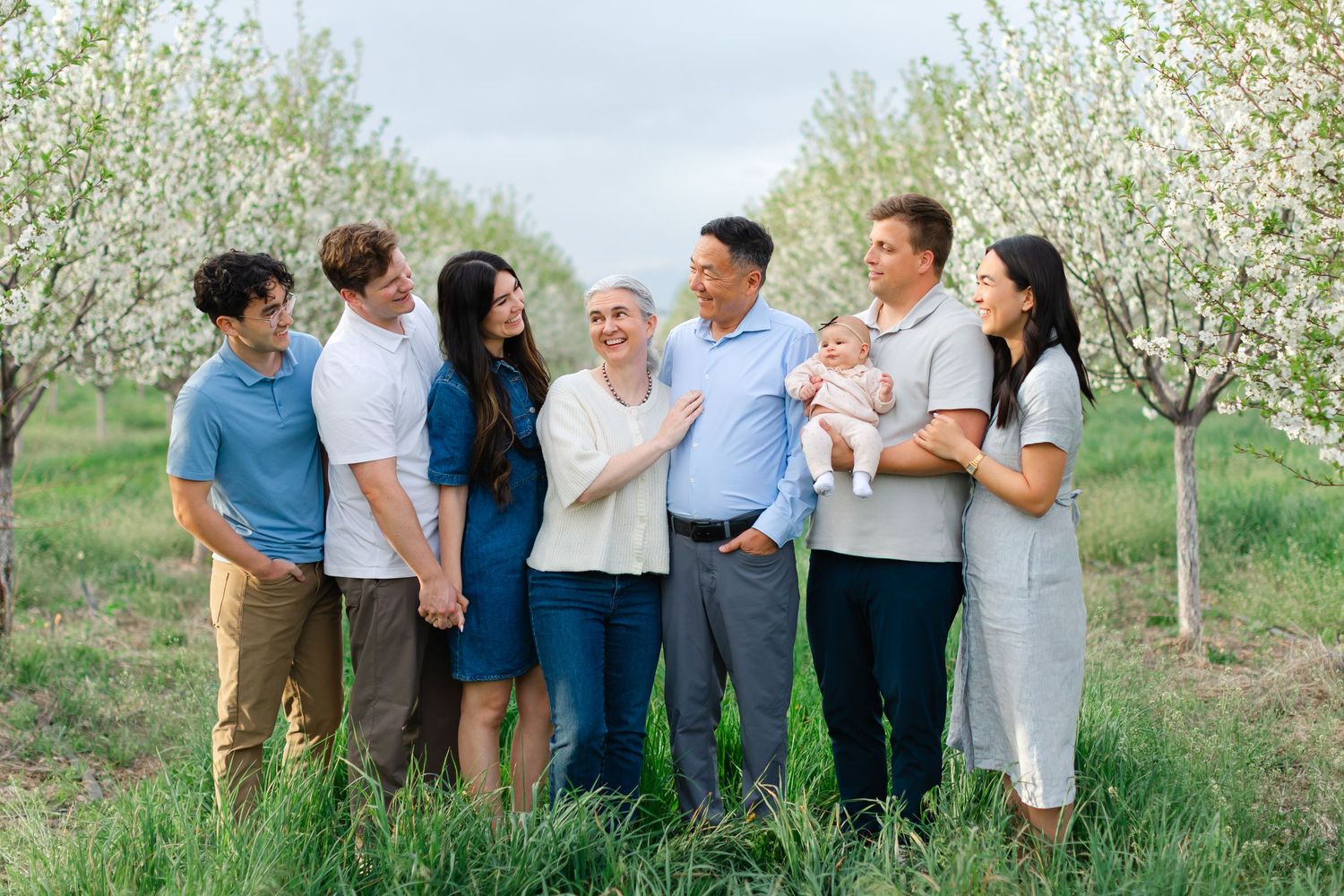 Extended Family Photography Session in Santaquin, Utah at a blossoming orchard in beautiful spring weather.