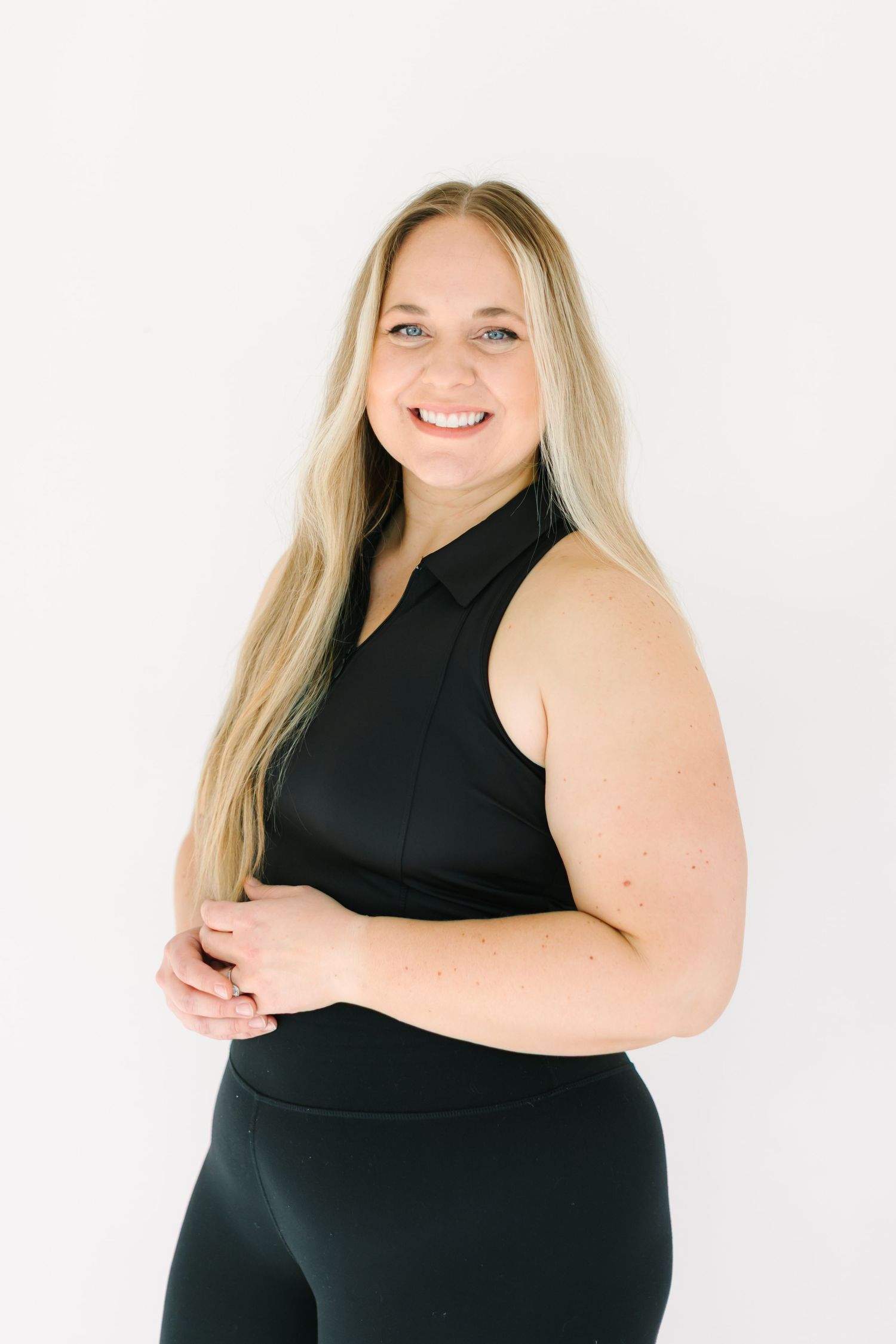 A series of four photos shows a person in a black sleeveless top posing confidently against a white background.